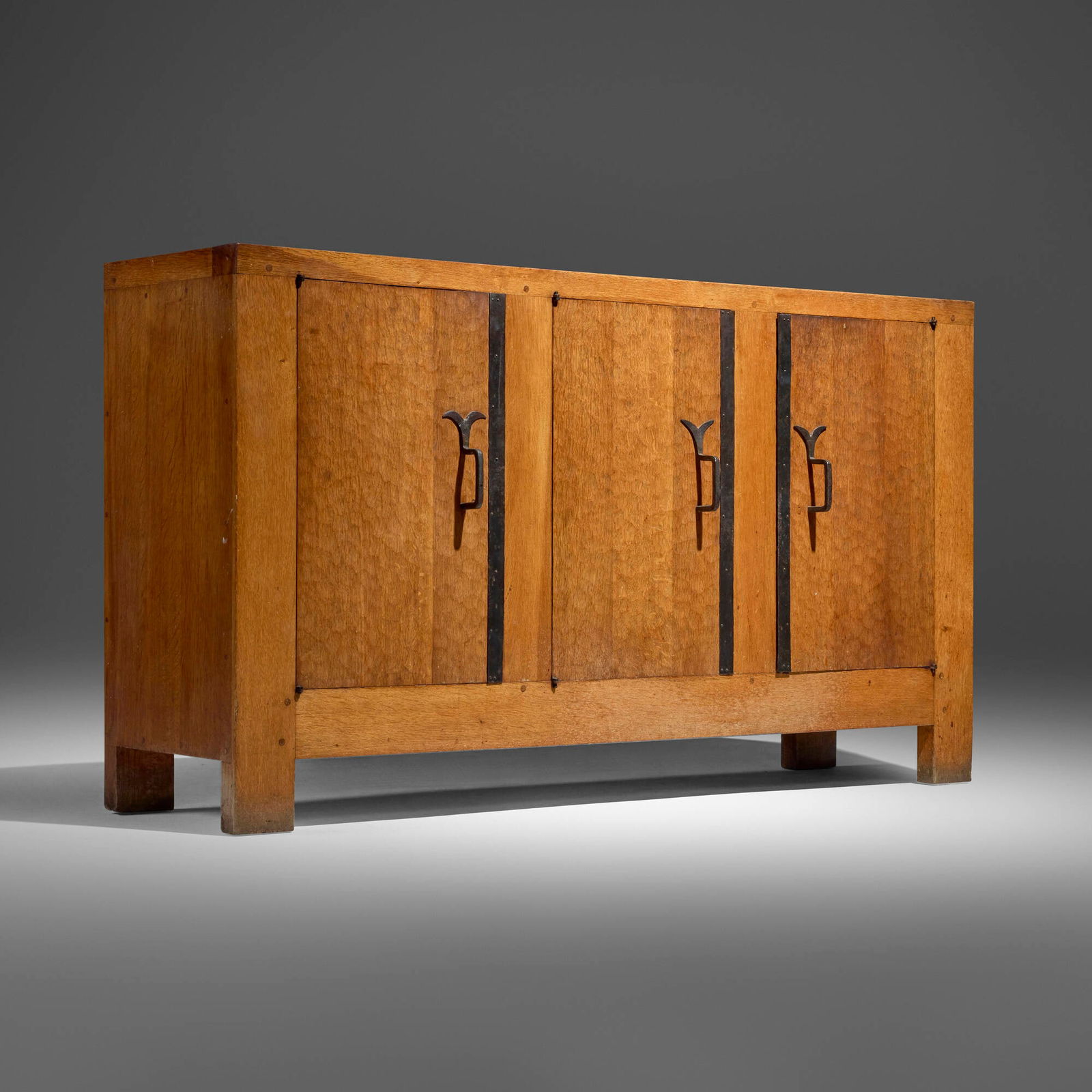 Jean Touret, Cabinet: Jean Touret Cabinet Atelier MarollesFrance, c. 1958solid oak, wrought iron 35.5 h x 63 w x 18 d in (90 x 160 x 46 cm) Cabinet features three doors with carved with honey-comb pattern and