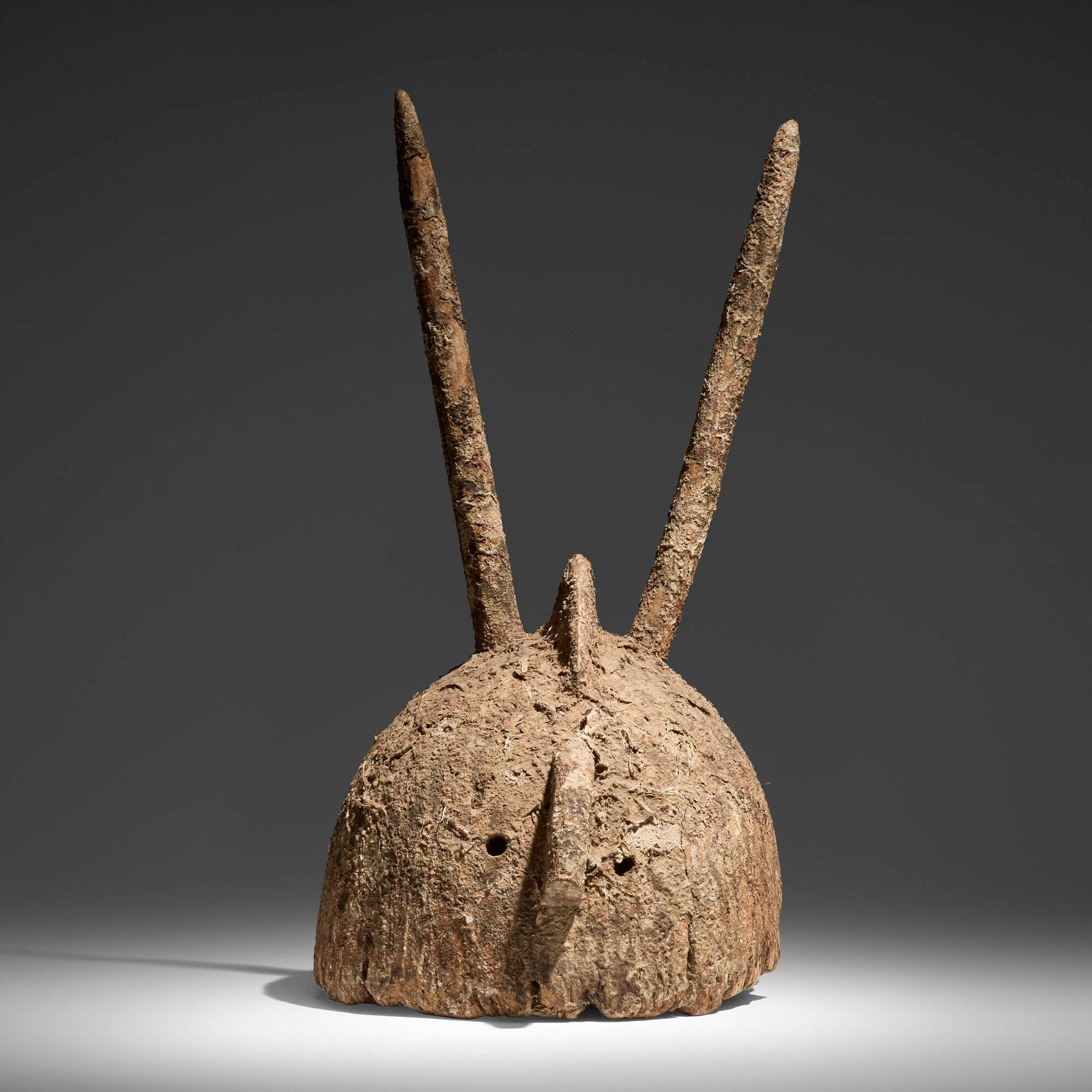 Bamana, Rare horned helmet mask: Bamana Rare horned helmet mask Mali, early to mid-20th centurycarved wood, clay, natural fibers 25 h x 13 w x 15 d in (63 x 33 x 38 cm) This work will ship from Los Angeles, Calif