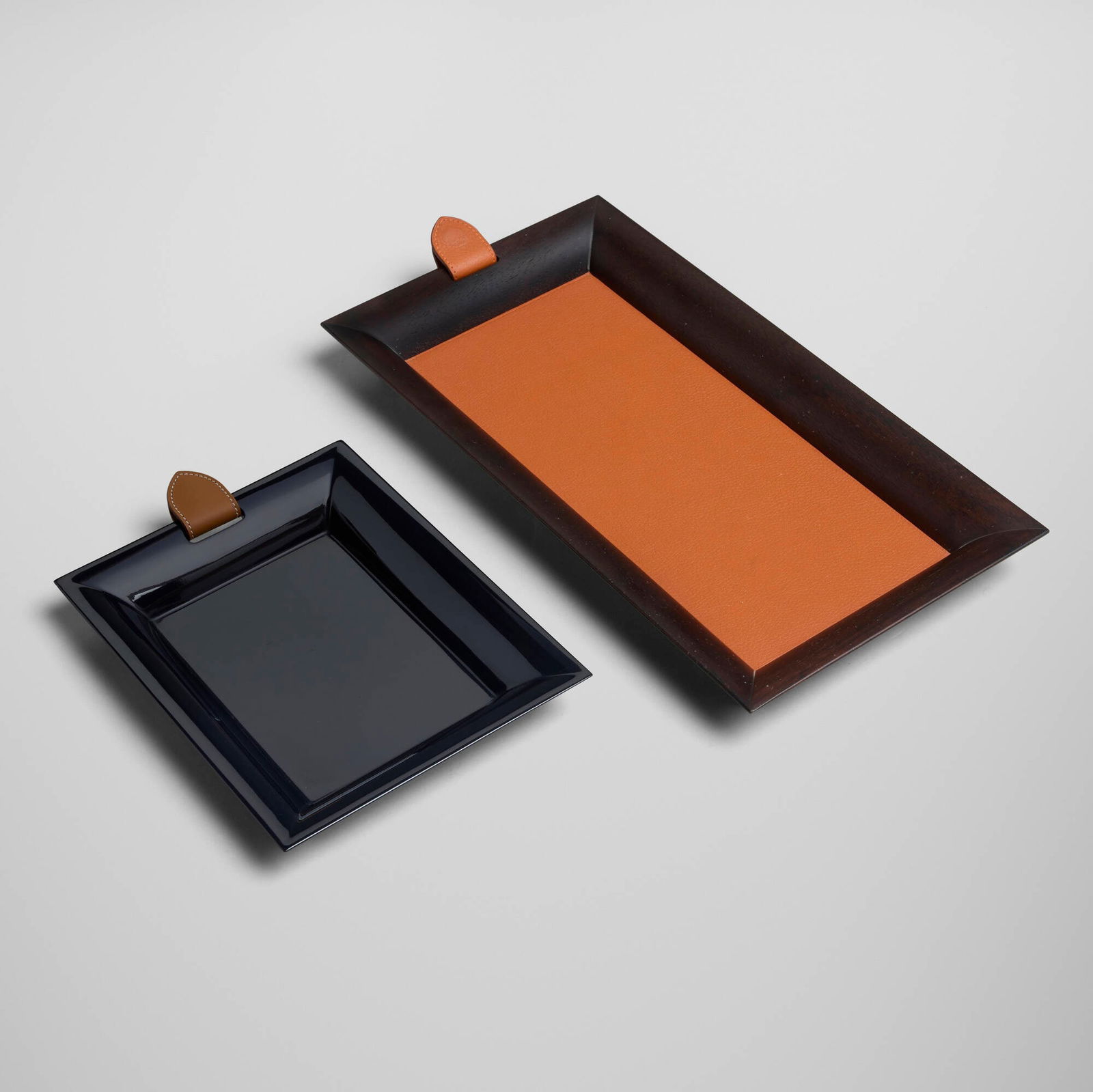 Hermes, Atrium trays, set of two: Hermes Atrium trays, set of two France / Italy, c. 2010rosewood, leather, lacquered wood 1.25 h x 13.75 w x 7.5 d in (3 x 35 x 19 cm) 1 h x 9 w x 6.5 d in (3 x 23 x 17 cm) Impressed and pri