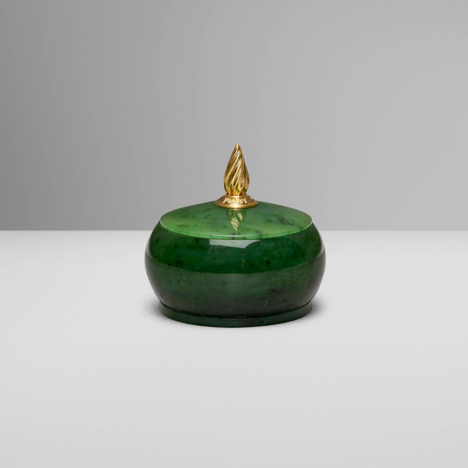 Piaget, Covered box: Piaget Covered box Switzerland, late 20th centurynephrite jade, 18k yellow gold 2.25 h x 2.25 dia in (6 x 6 cm) Impressed manufacturer's mark to finial 'Piaget 750 Geneve'.