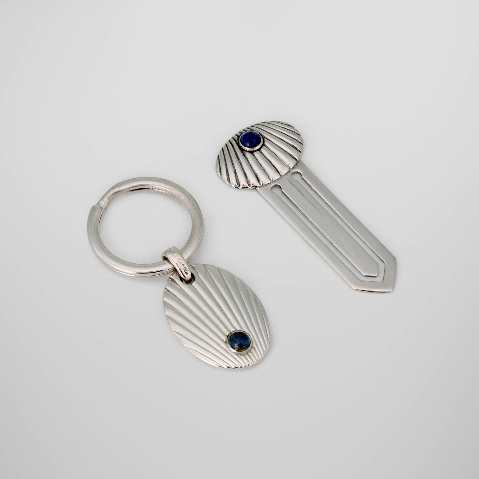 Cartier, Lapis Collection key ring and bookmark: Cartier Lapis Collection key ring and bookmark France, c. 2005sterling silver, lapis lazuli, parcel-gilt 2.25 h x 1 w x 0.25 d in (6 x 3 x 1 cm) 2.5 h x 1 w x 0.25 d in (6 x 3 x 1 cm) Impre