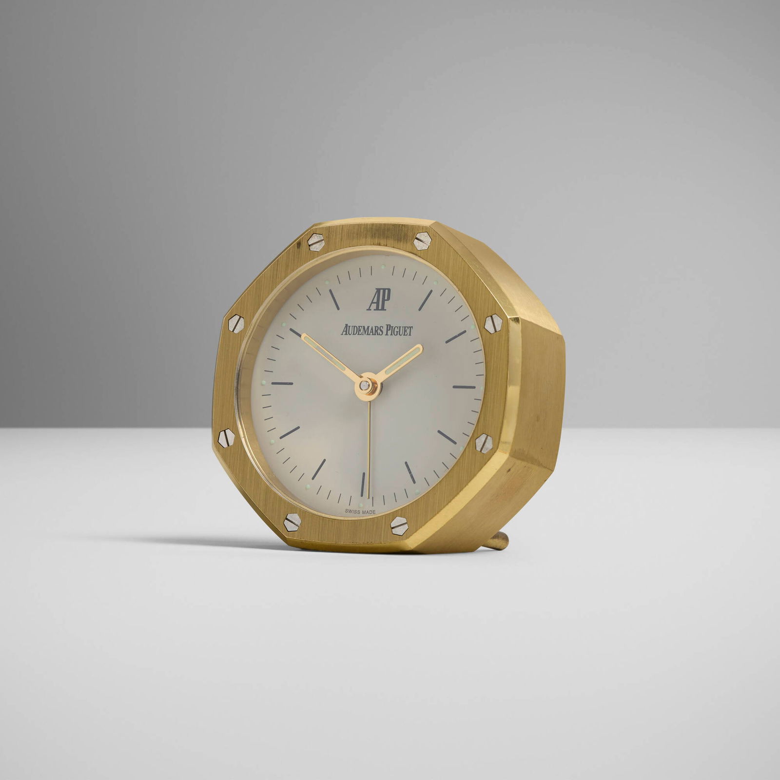 Audemars Piguet, Royal Oak table alarm clock: Audemars Piguet Royal Oak table alarm clock Switzerland, c. 2005brass, steel, glass 2.75 h x 2.75 w x 1.5 d in (7 x 7 x 4 cm) Printed manufacturer's mark to face 'Audemars Piguet' and to rever