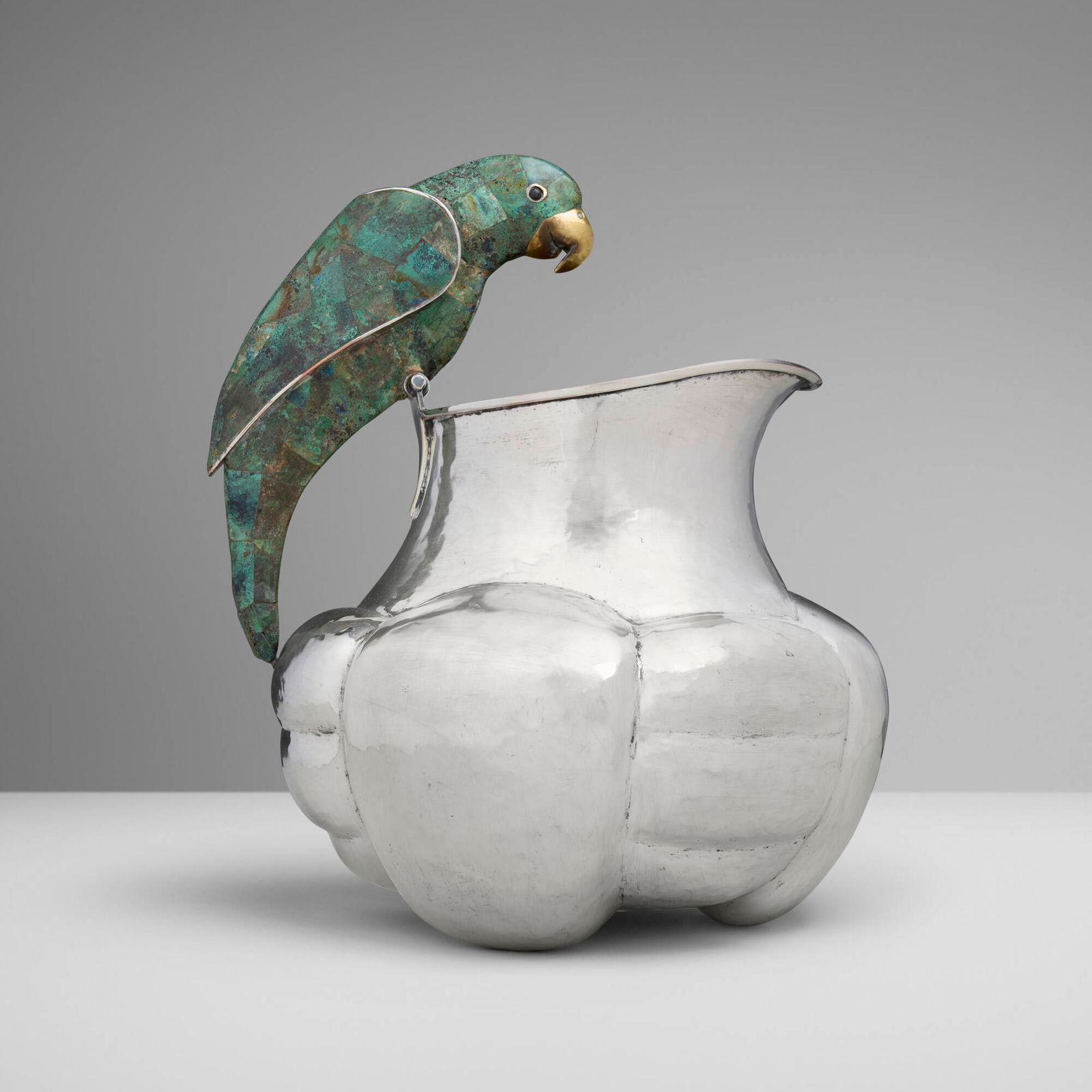 Emilia Castillo for Los Castillo, Pitcher with parrot handle: Emilia Castillo for Los Castillo Pitcher with parrot handle Mexico, c. 1980silver-plated metal, hardstone inlay, brass 11.75 h x 10 w x 8.5 d in (30 x 25 x 22 cm) Impressed manufacturer's mark
