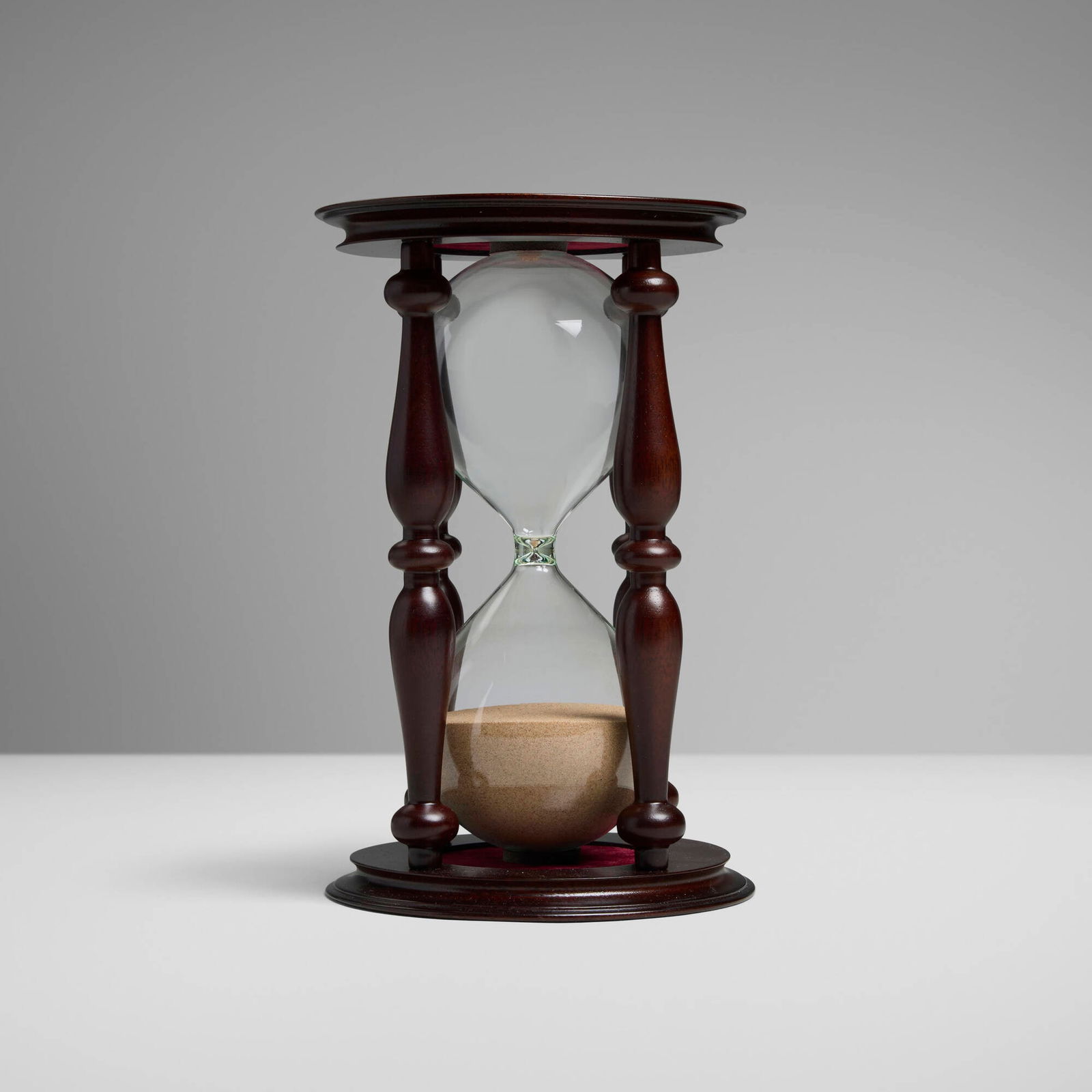 Asprey & Garrard Limited, Elizabeth II hourglass: Asprey & Garrard Limited Elizabeth II hourglass United Kingdom, 2000 stained mahogany, glass, sterling silver, sand 8.5 h x 5.5 dia in (22 x 14 cm) Impressed maker's mark and English hallmarks to