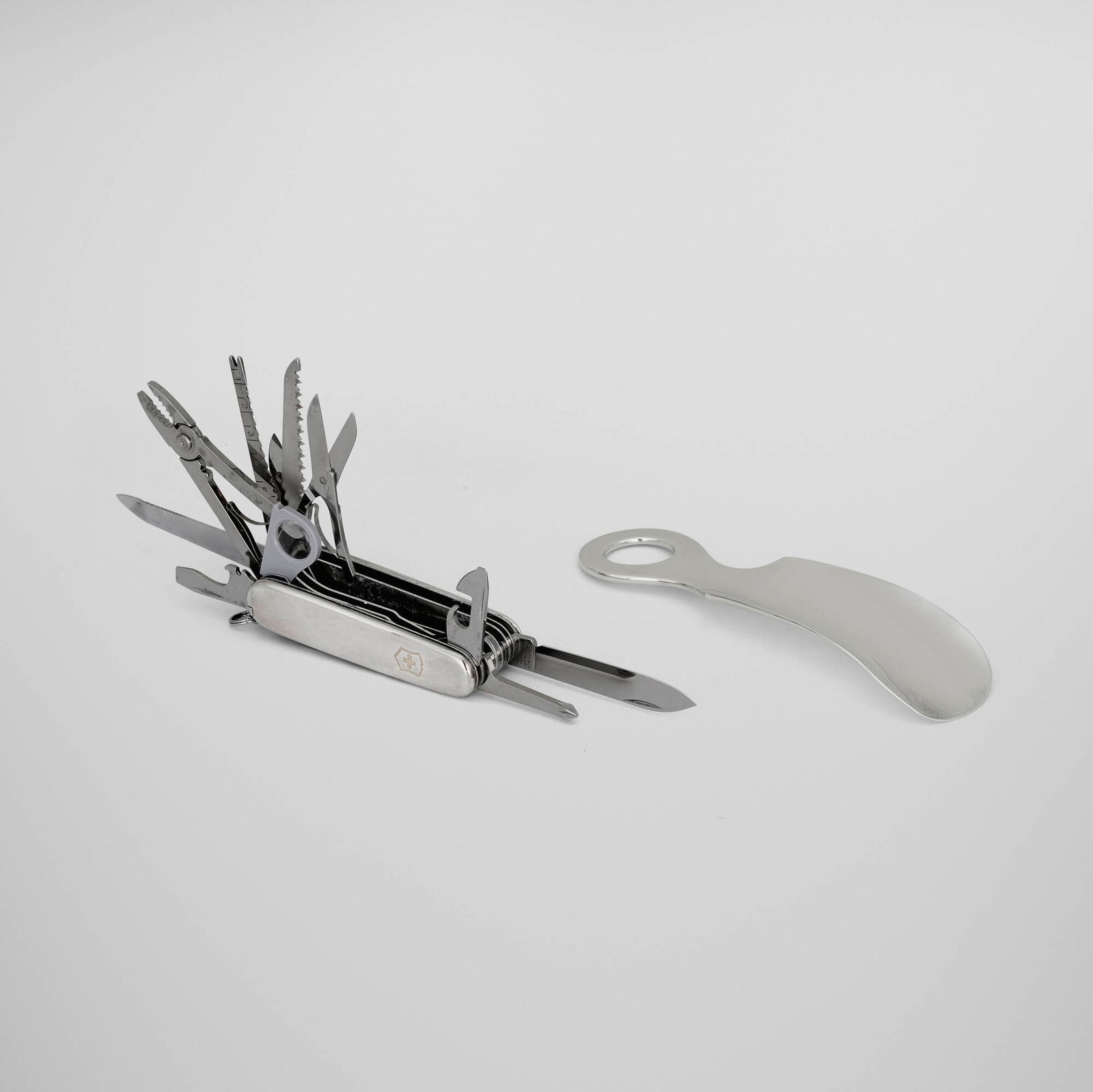 Tiffany & Co., Shoe horn and Swiss pocket knife: Tiffany & Co. Shoe horn and Swiss pocket knife New York, USA, 20th century sterling silver, stainless steel, 18k gold, acrylic, glass knife: 1 h x 3.5 w x 1.5 d in (3 x 9 x 4 cm) shoehorn: 0.75 h x