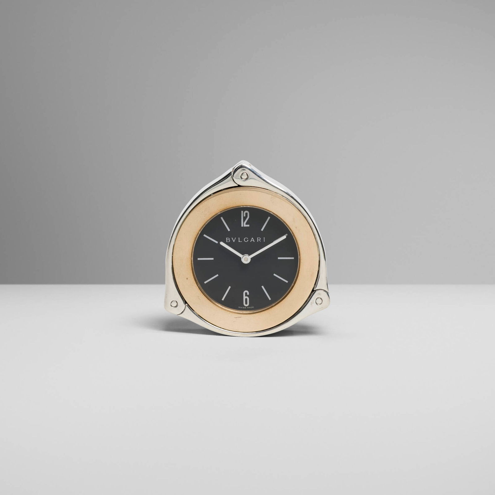 Bulgari, Cerniera SB travel clock: Bulgari Cerniera SB travel clock Italy / Switzerland, c. 2000 sterling silver, gold-plated metal, glass 3.25 h x 3.25 w x 1 d in (8 x 8 x 3 cm) Stamped manufacturer's mark to reverse 'Bvlgari