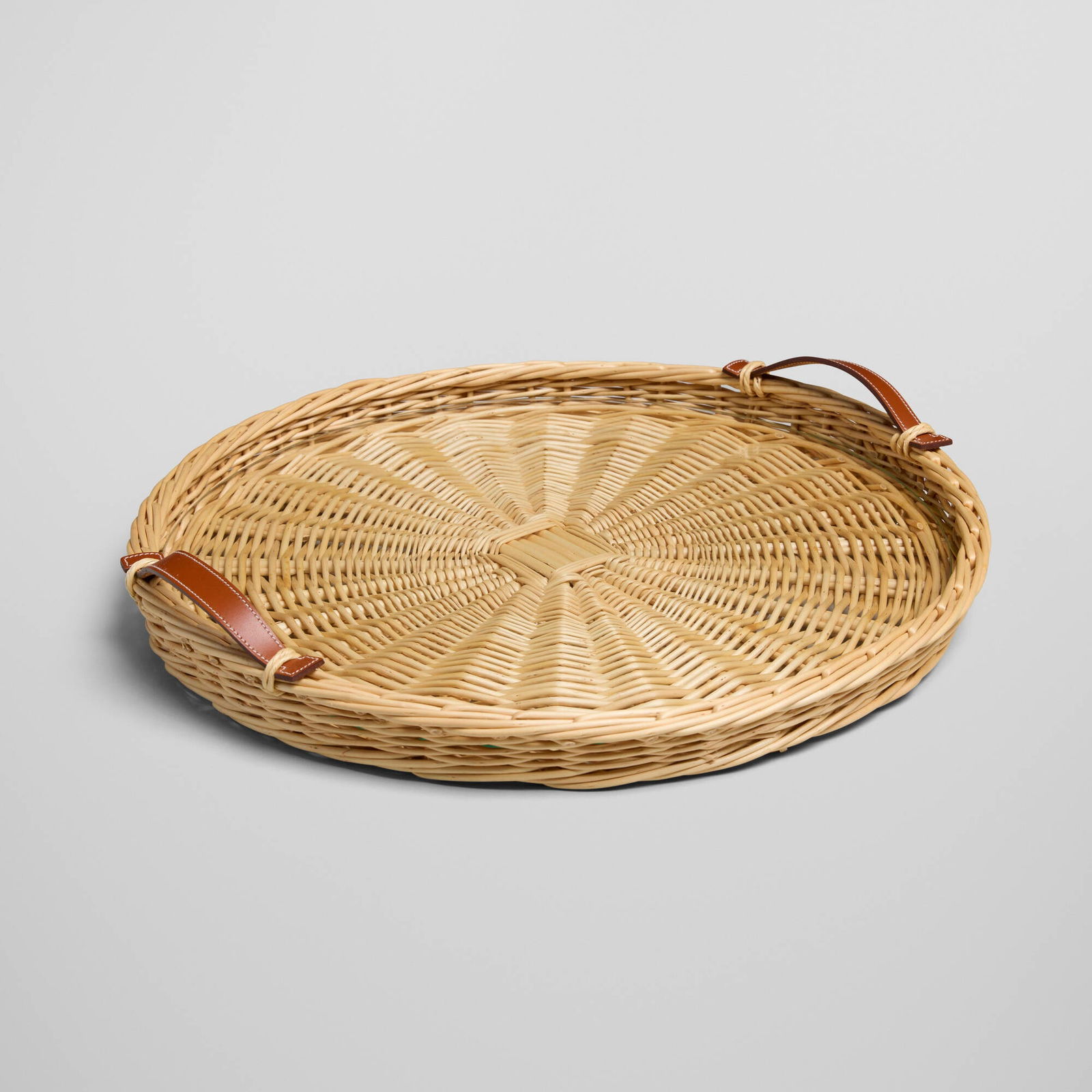 Hermes, Oseraie round tray: Hermes Oseraie round tray France, c. 2010wicker, glass, leather 3 h x 17 dia in (8 x 43 cm) Impressed manufacturer's mark to handle 'Hermes Paris'. Sold with original box.