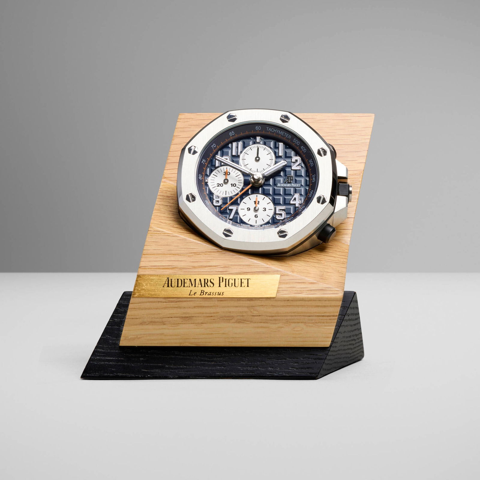 Audemars Piguet, Royal Oak Offshore table clock: Audemars Piguet Royal Oak Offshore table clock Switzerland, 2018 stainless steel, glass, oak, painted wood 4.25 h x 4.25 w x 3 d in (11 x 11 x 8 cm) Printed manufacturer's mark to dial 'Audemars