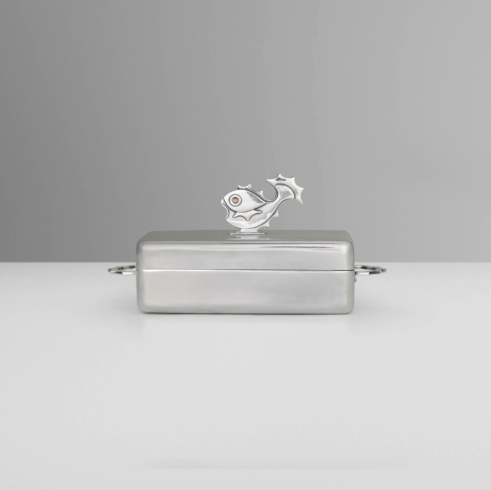 Wellner, Covered butter dish with fish finial: Wellner Covered butter dish with fish finial Germany, c. 1965 silver-plated metal, glass 3.75 h x 7.5 w x 3.5 d in (10 x 19 x 9 cm) Impressed manufacturer's mark to underside 'Wellner'. 