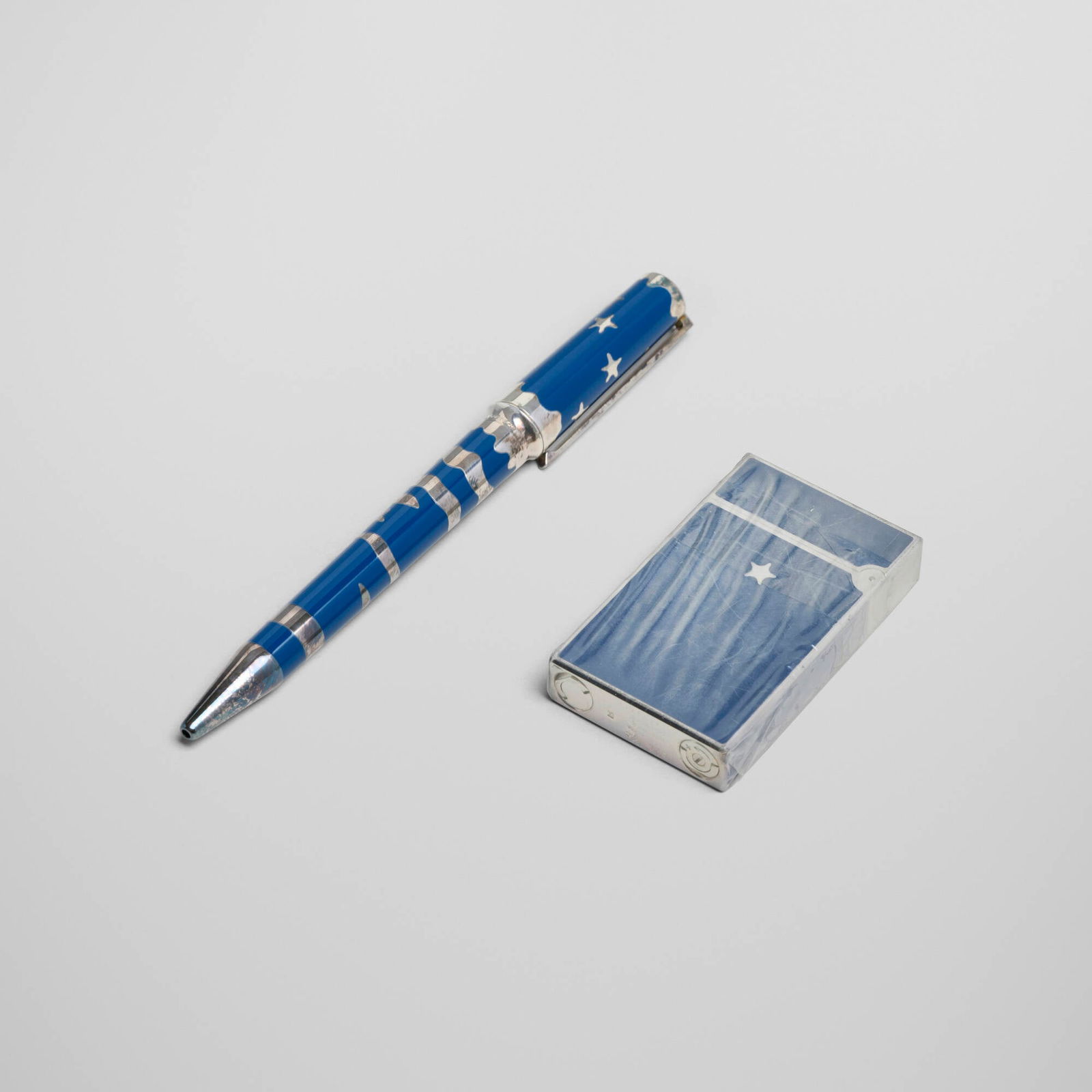 S.T. Dupont, Rendez-Vous pocket lighter and ball pen: S.T. Dupont Rendez-Vous pocket lighter and ball pen France, 1996 lacquer, silver-plated metal pen: 5.25 h x 0.625 w x 0.5 d in (13 x 2 x 1 cm) lighter: 2.375 h x 1.5 w x 0.375 d in (6 x 4 x 1 cm) 