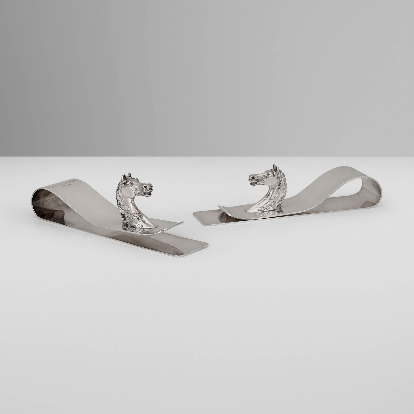 Hermes, Horse Head paper clips, pair: Hermes Horse Head paper clips, pair Ravinet d'Enfert & CieFrance, c. 1965silver-plated metal 2.75 h x 8.75 w x 2 d in (7 x 22 x 5 cm) Impressed manufacturer's mark to underside of each e