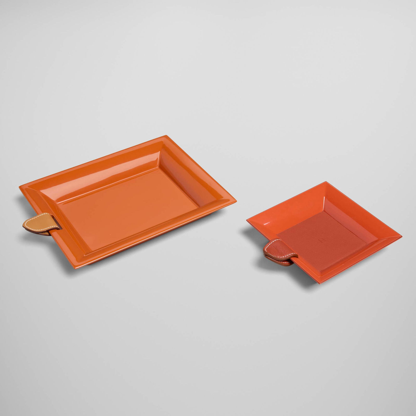 Hermes, Atrium trays, set of two: Hermes Atrium trays, set of two France / Vietnam, c. 2010 lacquered wood, leather 1 h x 8.25 w x 6.5 d in (3 x 21 x 17 cm) 1 h x 4.75 w x 5 d in (3 x 12 x 13 cm) Impressed manufacturer's mark to