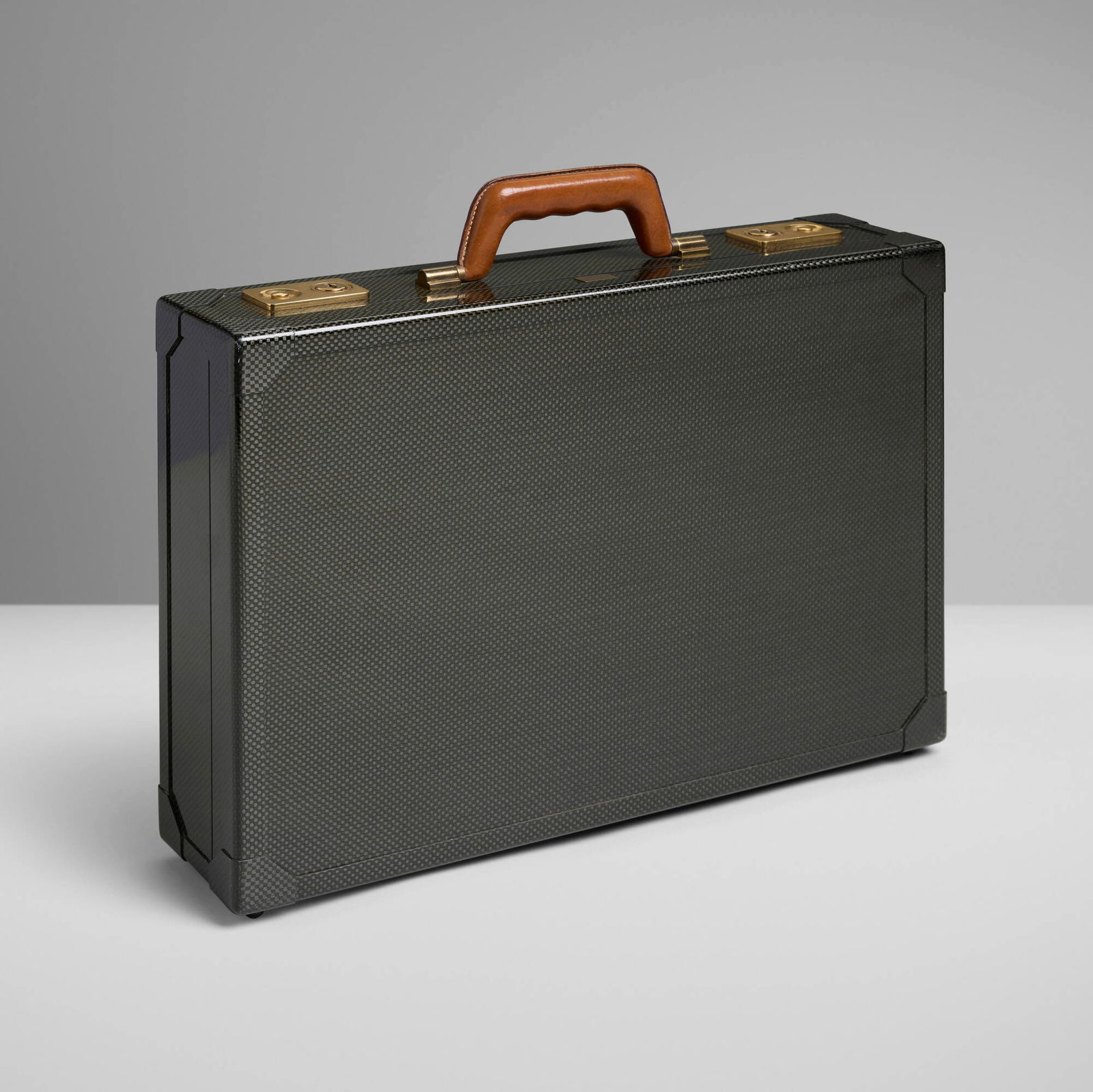 Hermes, Espace attache: Hermes Espace attache France, 1987 carbon fiber, gold-plated brass, leather 14 h x 16.5 w x 4 d in (36 x 42 x 10 cm) Attache features a clochette and two keys. Impressed manufacturer's mark to