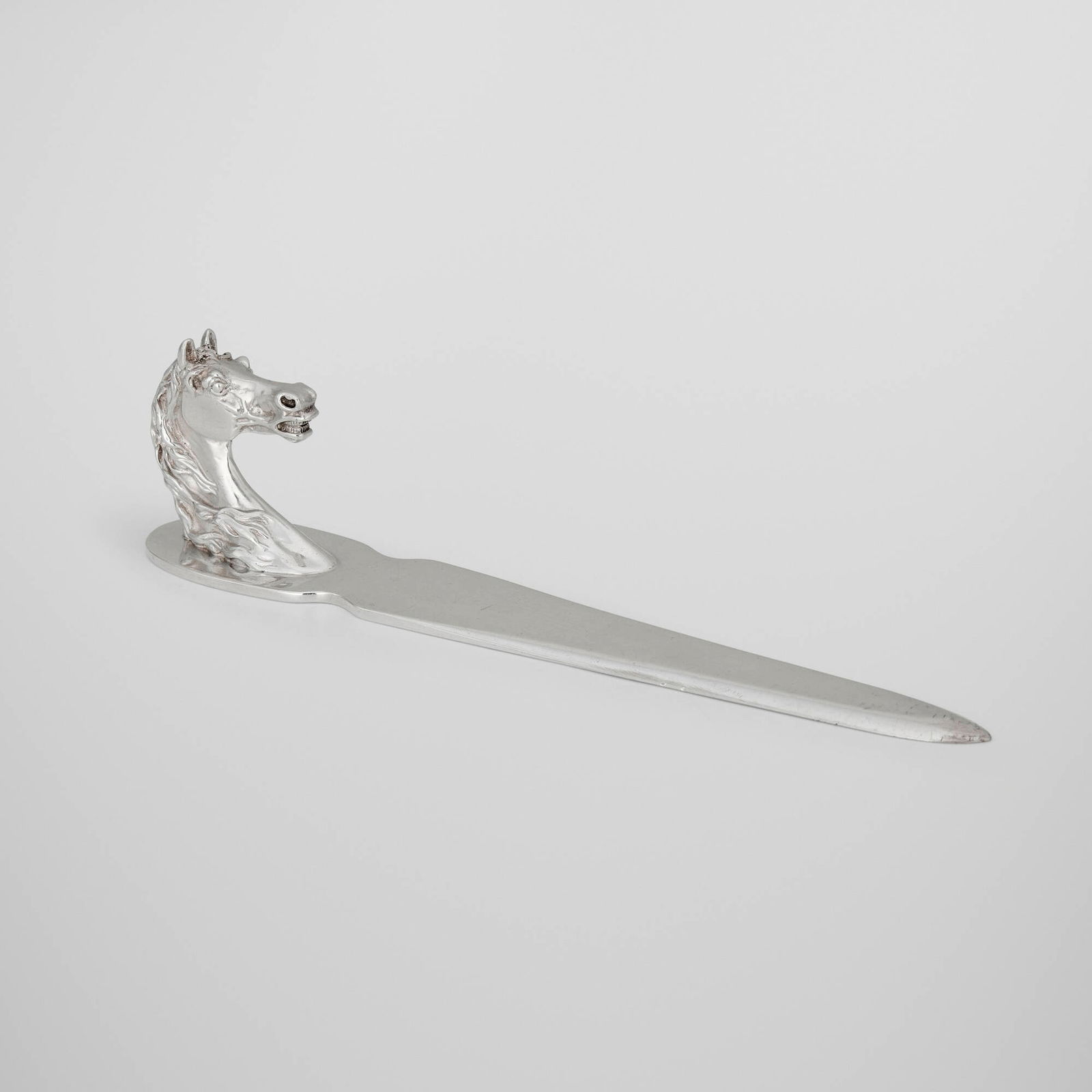 Hermes, Horse Head letter opener: Hermes Horse Head letter opener Ravinet d'Enfert & Cie France, c. 1965 silver-plated metal 2.25 h x 8.75 w x 1.25 d in (6 x 22 x 3 cm) Impressed manufacturer's mark to underside 'Hermes Paris'