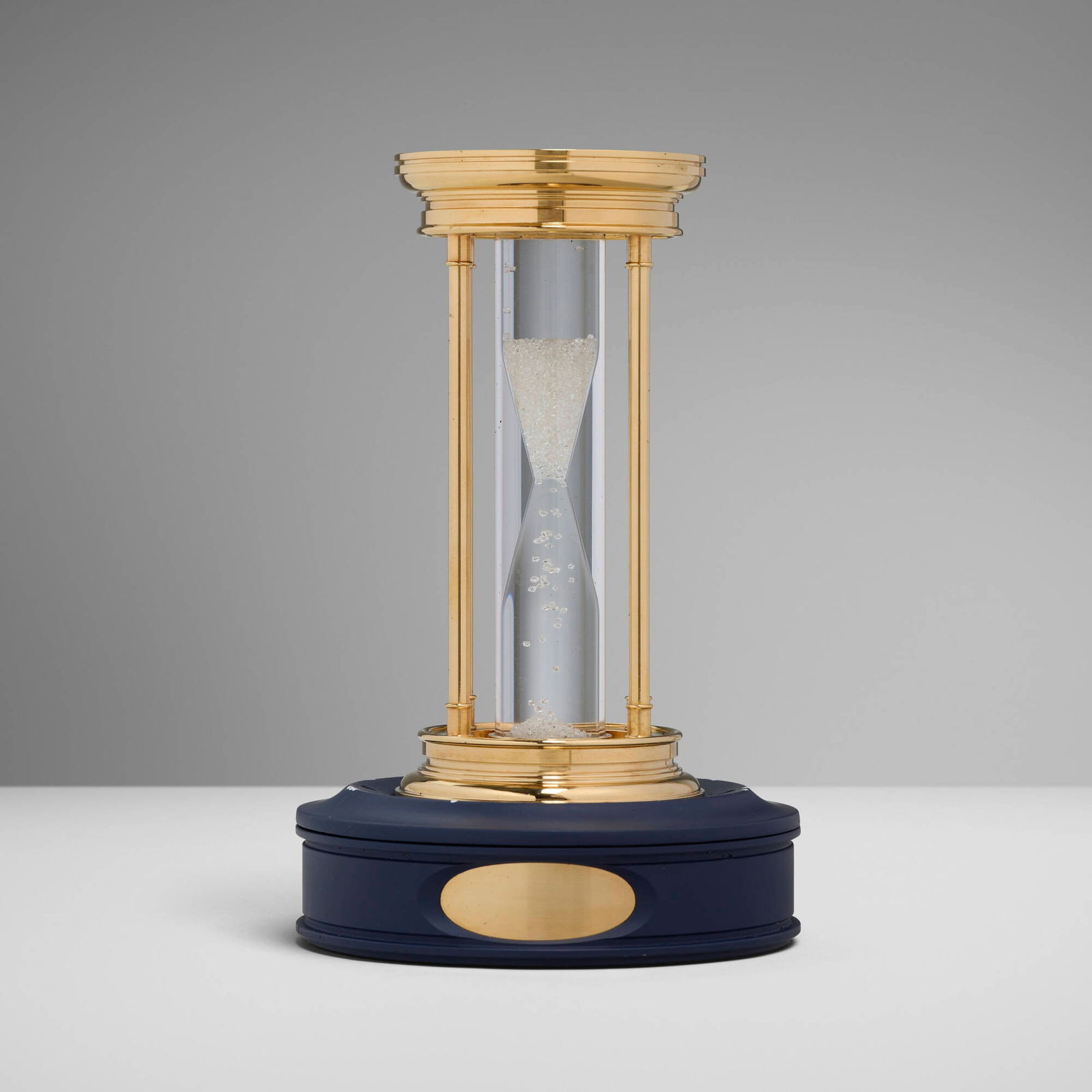 De Beers and Louis Glick & Company, Diamond hourglass: De Beers and Louis Glick & Company Diamond hourglass c. 2000gold-plated metal, rough diamonds, acrylic, silicone fluid 5.75 h x 2.75 dia in (15 x 7 cm) This limited edition hourglass contains