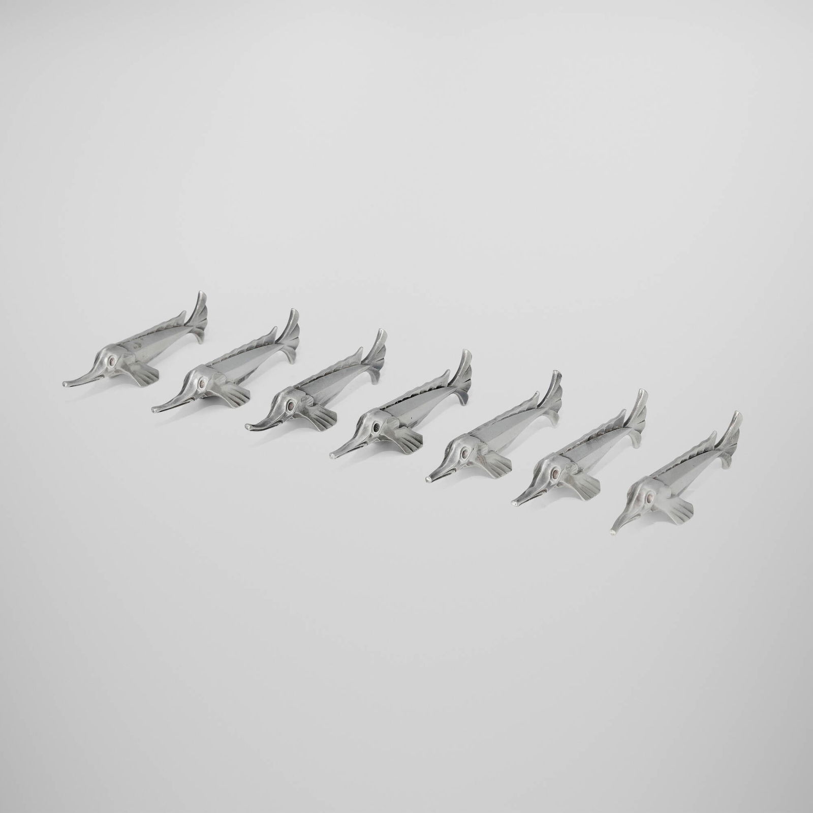 Edouard-Marcel Sandoz, Gallia sturgeon knife rests, set of seven: Edouard-Marcel Sandoz Gallia sturgeon knife rests, set of seven ChristofleSwitzerland / France, c. 1930silver-plated metal 1 h x 4.25 w x 0.75 d in (3 x 11 x 2 cm) Impressed manufacturer