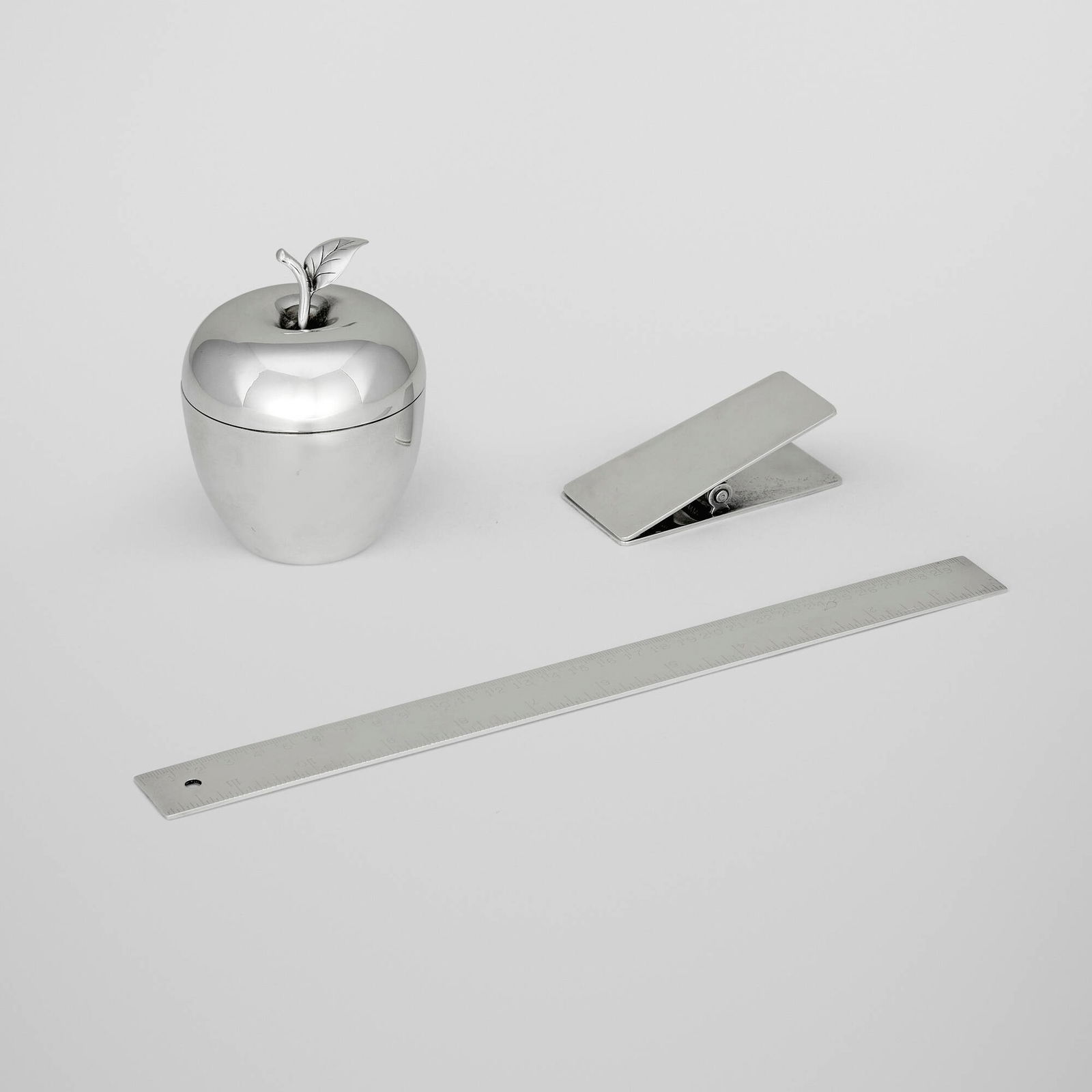 Tiffany & Co., Collection of three desk articles: Tiffany & Co. Collection of three desk articles New York, USA, 20th century sterling silver apple: 4.25 h x 3.25 dia in (11 x 8 cm) clip: 1.25 h x 3.75 w x 1.75 d in (3 x 10 x 4 cm) ruler: 0.125 h