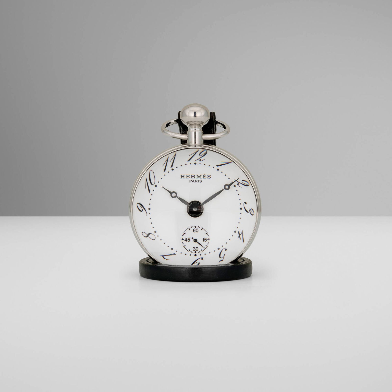 Hermes, Ball clock: Hermes Ball clock France / Switzerland, c. 2000 glass, silver-plated metal, leather 3 h x 3 dia in (8 x 8 cm) Impressed manufacturer's mark to edge 'Hermes Paris PE-BO1.810 2318255'. Sold with