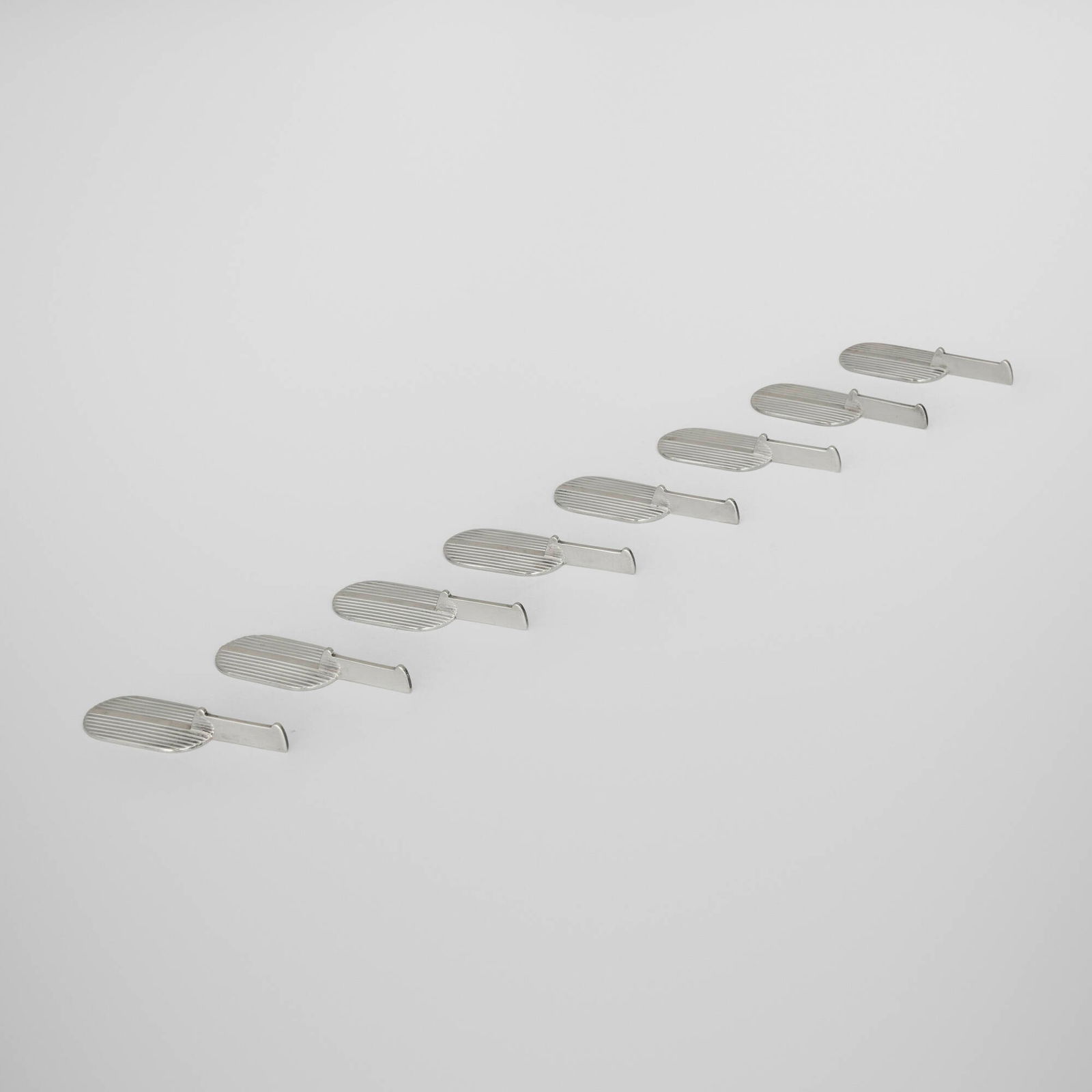 Cardeilhac, Strie knife rests, set of eight: Cardeilhac Strie knife rests, set of eight France, c. 1930 silver 0.375 h x 2.75 w x 1 d in (1 x 7 x 3 cm) Impressed maker's mark and French hallmark to each example 'Cardeilhac Paris Depose'.