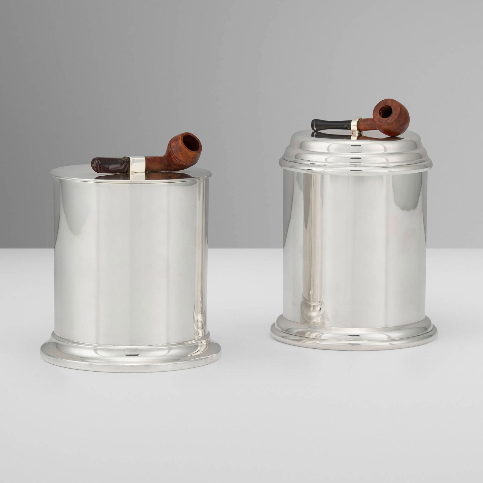 English, Tobacco canisters with pipe finials, set of two: English Tobacco canisters with pipe finials, set of two 1906, 1996 silver, walnut, glass 5.5 h x 3.75 dia in (14 x 10 cm) 5 h x 3.75 dia in (13 x 10 cm) Set is comprised of an Edwardian example by