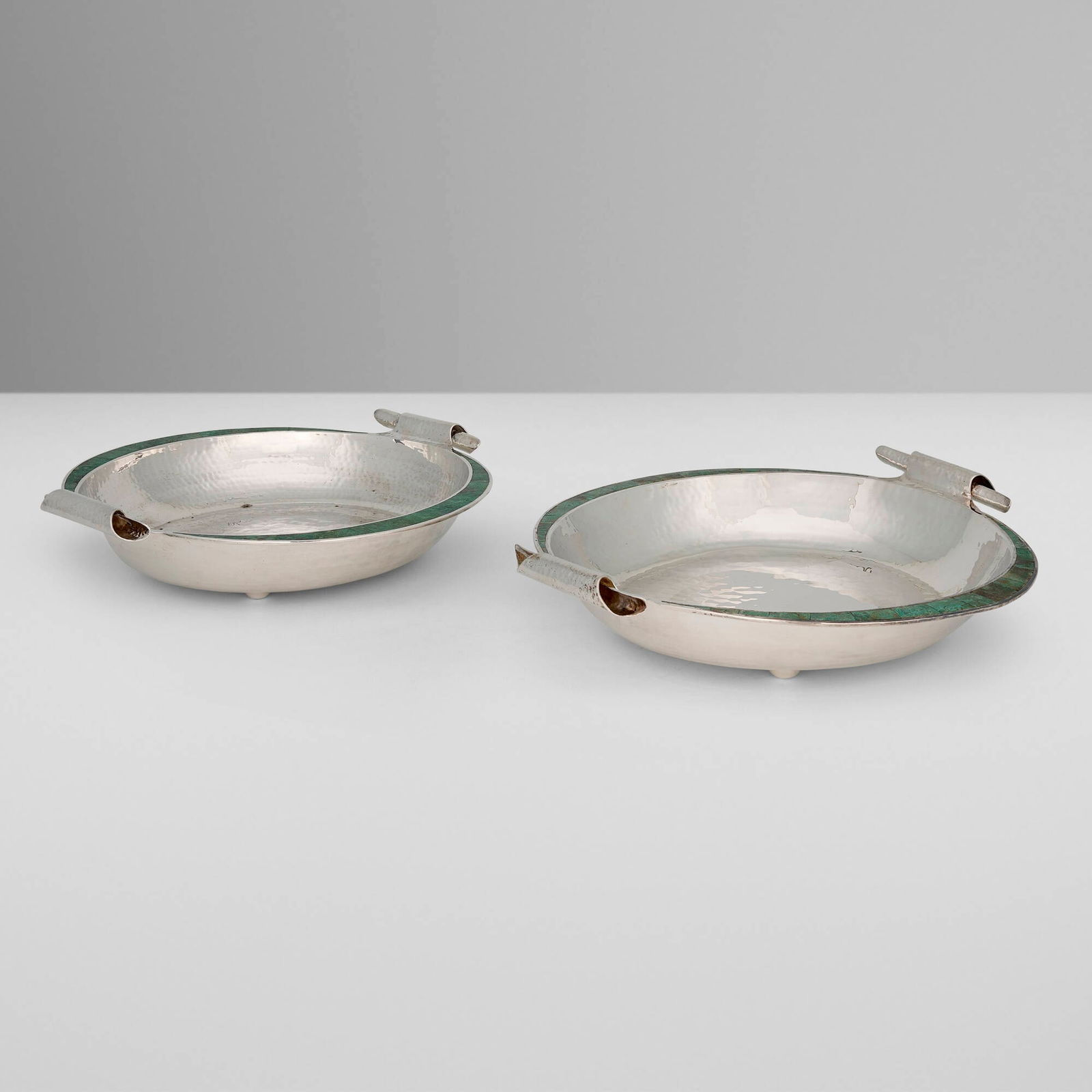 Emilia Castillo, Centerpieces, pair: Emilia Castillo Centerpieces, pair Mexico, c. 1995 silver-plated metal, hardstone inlay 3.75 h x 16.5 dia in (10 x 42 cm) Impressed manufacturer's mark to underside of each example 'Emilia