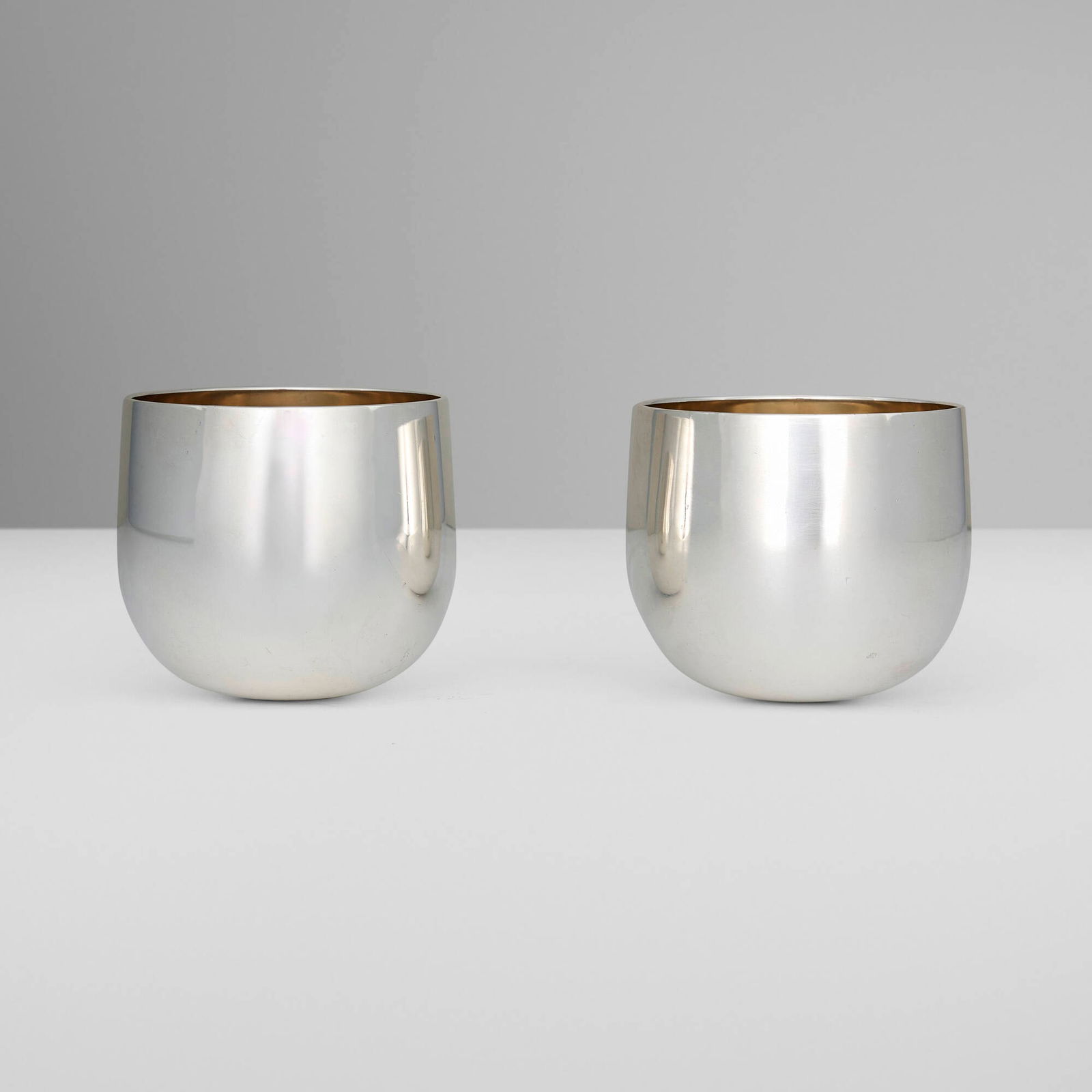 Bulgari, Rocking tumblers, pair: Bulgari Rocking tumblers, pair Italy, c. 1975 sterling silver parcel-gilt 3 h x 3.25 dia in (8 x 8 cm) Impressed manufacturer's mark to rim of each example 'Bvlgari 925' with Roman maker's mark.