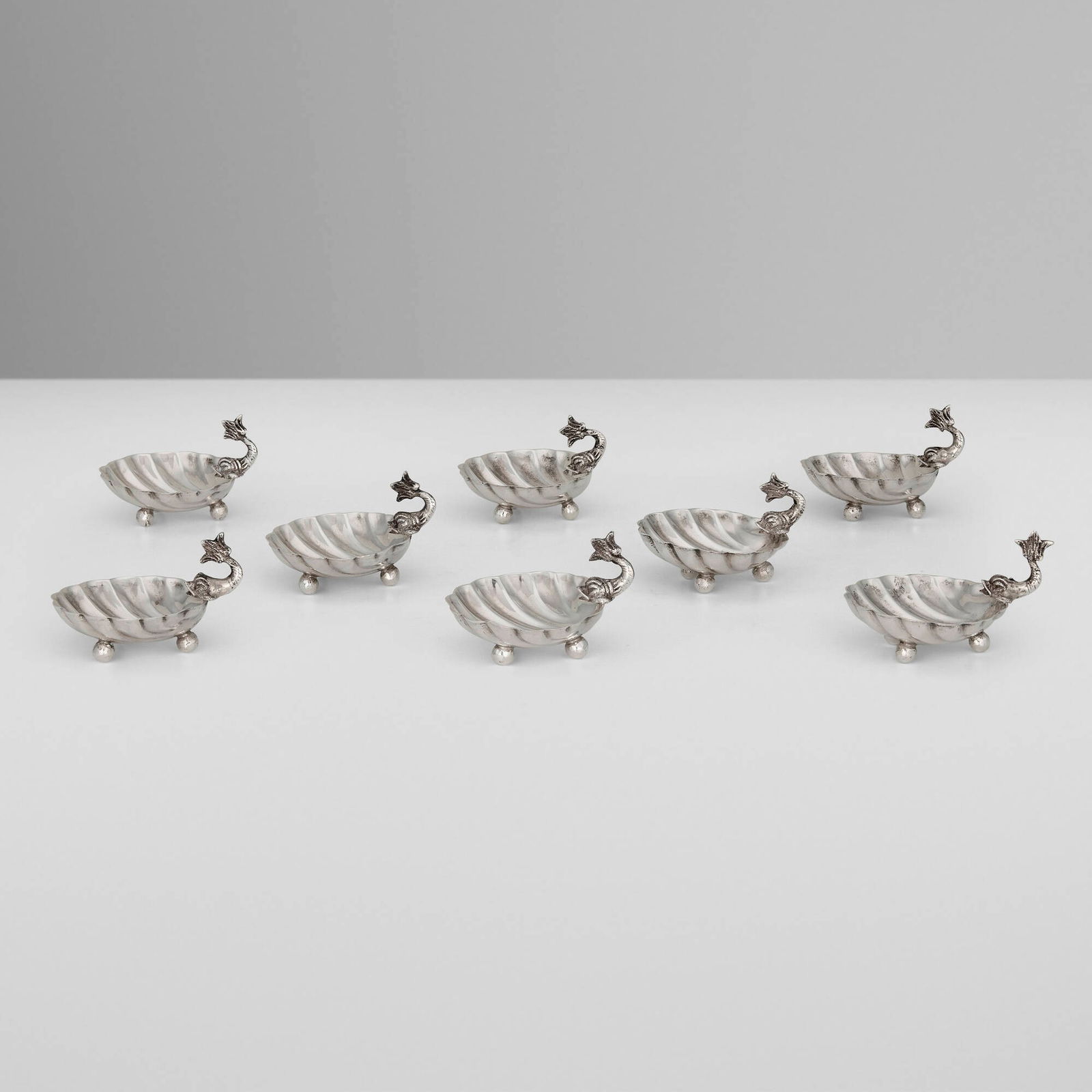 Egyptian, Shell and dolphin salt cellars, set of eight: Egyptian Shell and dolphin salt cellars, set of eight 1946-1965 silver 1.25 h x 2.25 dia in (3 x 6 cm) Impressed Egyptian hallmarks to underside of each example. 7.70 ozt. Provenance: Private