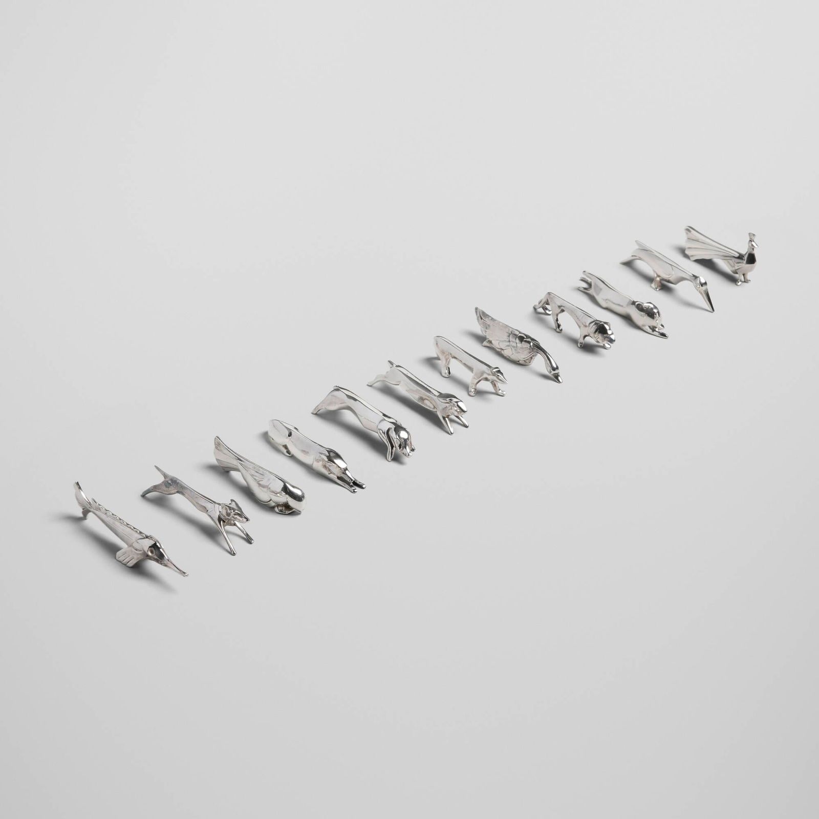 Edouard-Marcel Sandoz, Gallia animalier knife rests, set of twelve: Edouard-Marcel Sandoz Gallia animalier knife rests, set of twelve Christofle Switzerland / France, c. 1930 / c. 1940 silver-plated metal 1 h x 3 w x 0.5 d in (3 x 8 x 1 cm) Set is comprised of a