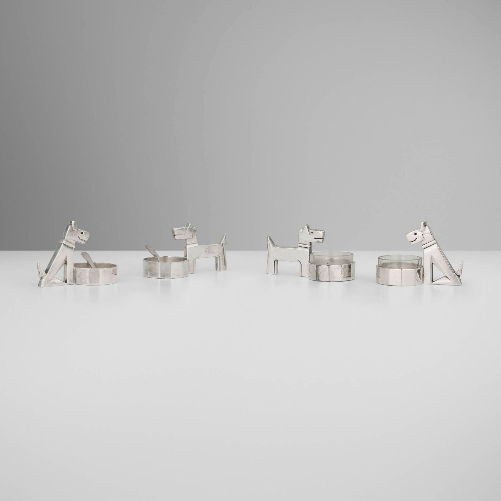 After Pol Rab, Gallia Ric & Rac salt cellars, set of four: After Pol Rab Gallia Ric & Rac salt cellars, set of four Christofle France c. 1925 / c. 1940 silver-plated metal, glass cellar: 2 h x 3.5 w x 1.75 d in (5 x 9 x 4 cm) spoon: 0.375 h x 2.5 w x 0.75