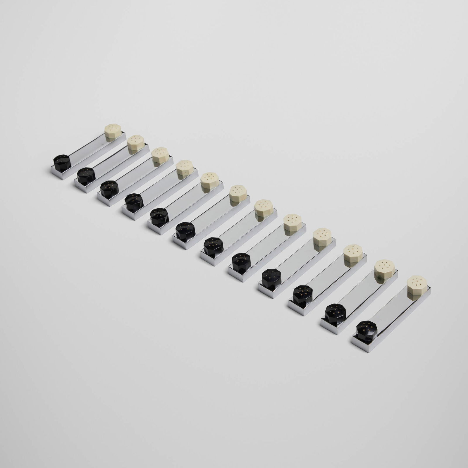 Art Deco, Knife rests with salt and pepper shakers, set of twelve: Art Deco Knife rests with salt and pepper shakers, set of twelve c. 1935silver-plated metal, plastic 0.75 h x 3.75 w x 0.75 d in (2 x 10 x 2 cm) Provenance: Private European C