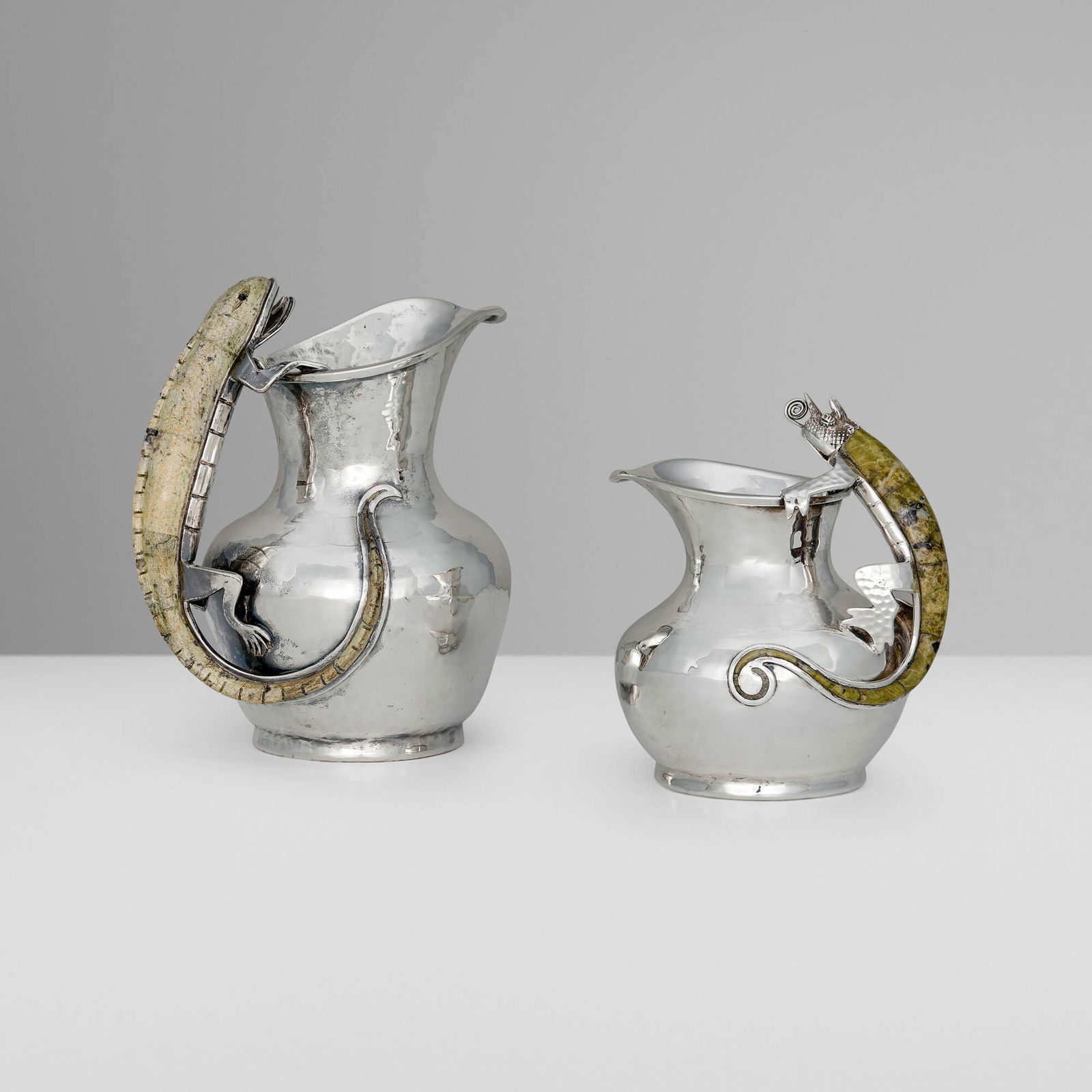 Los Castillo, Pitchers, set of two: Los Castillo Pitchers, set of two Mexico, c. 1980silver-plated metal, hardstone inlay 7 h x 6 w x 4 d in (18 x 15 x 10 cm) 5.5 h x 5 w x 4 d in (14 x 13 x 10 cm) Set is comprised of one