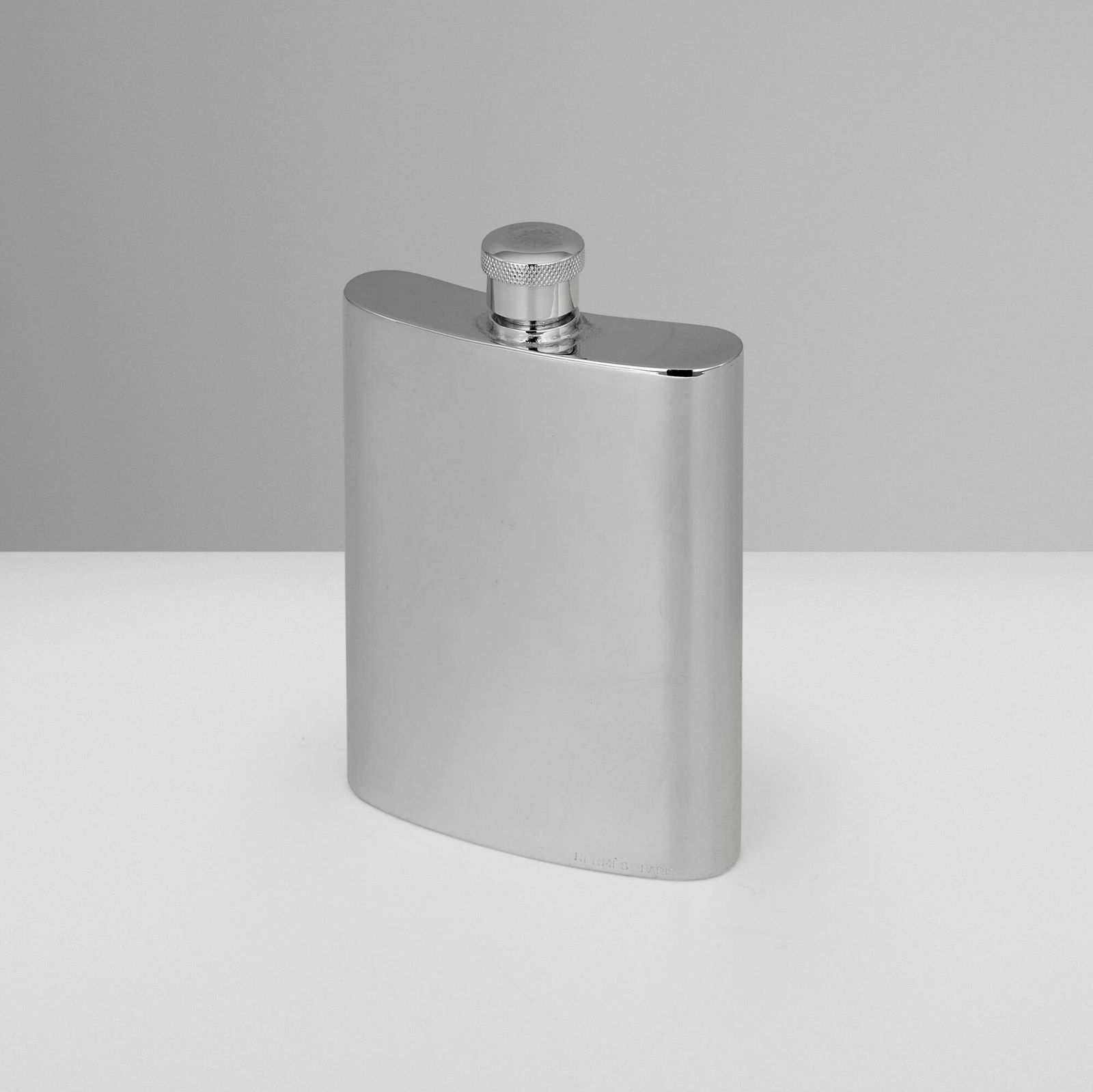 Hermes, Hip flask: Hermes Hip flask P.H. Vogel & Co.United Kingdom c. 1965electroplated nickel silver 4 h x 2.5 w x 0.5 d in (10 x 6 x 1 cm) Impressed manufacturer's and retailer's marks to edge 'Hermes Pa