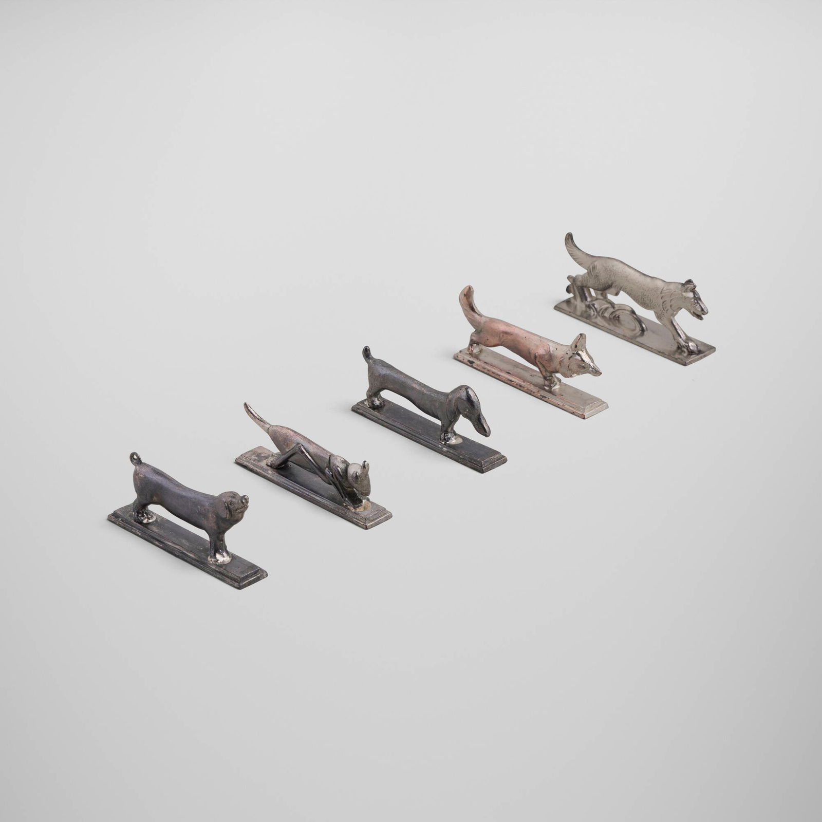 Art Deco, Animal knife rests, set of five: Art Deco Animal knife rests, set of five c. 1935 cast metal largest: 0.5 h x 3.5 w x 0.75 d in (1 x 9 x 2 cm) smallest: 1 h x 3 w x 0.5 d in (3 x 8 x 1 cm) Set is comprised of a dachshund, a pig,
