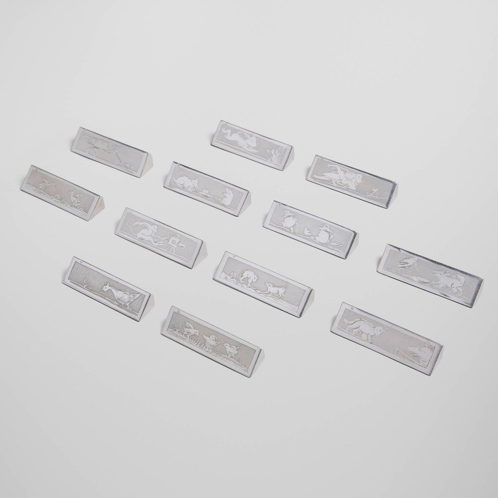 Stephane Prudhomme, Aesop's Fables knife rests, set of twelve: Stephane Prudhomme Aesop's Fables knife rests, set of twelve France, c. 1930silver-plated metal 0.75 h x 3.25 w x 1 d in (2 x 8 x 3 cm) Impressed maker's mark to edge of each example. Sold wit
