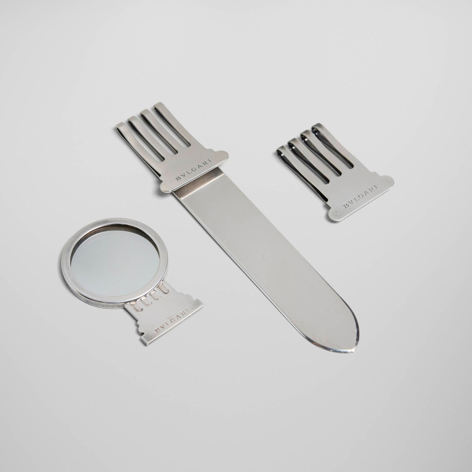 Bulgari, Collection of three works: Bulgari Collection of three works Italy, second half of the 20th century sterling silver, mirrored glass 6.75 h x 1.5 w x 0.25 d in (17 x 4 x 1 cm) 2.75 h x 2 w x 0.25 d in (7 x 5 x 1 cm) 2 h x 1.5