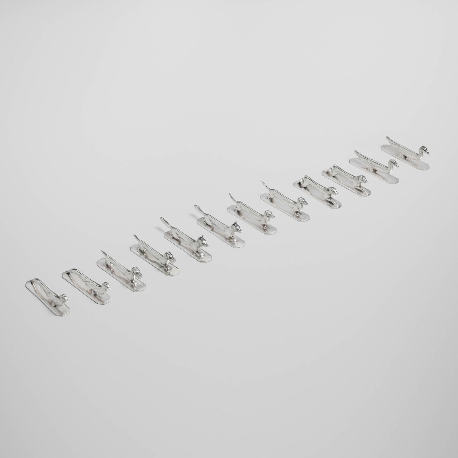 Orfevrerie Apollo, Animalier knife rests, set of twelve: Orfevrerie Apollo Animalier knife rests, set of twelve France, c. 1930 silver-plated metal 1.5 h x 4.25 w x 0.75 d in (4 x 11 x 2 cm) Set is comprised of two rabbits, two foxes, two pheasants, two