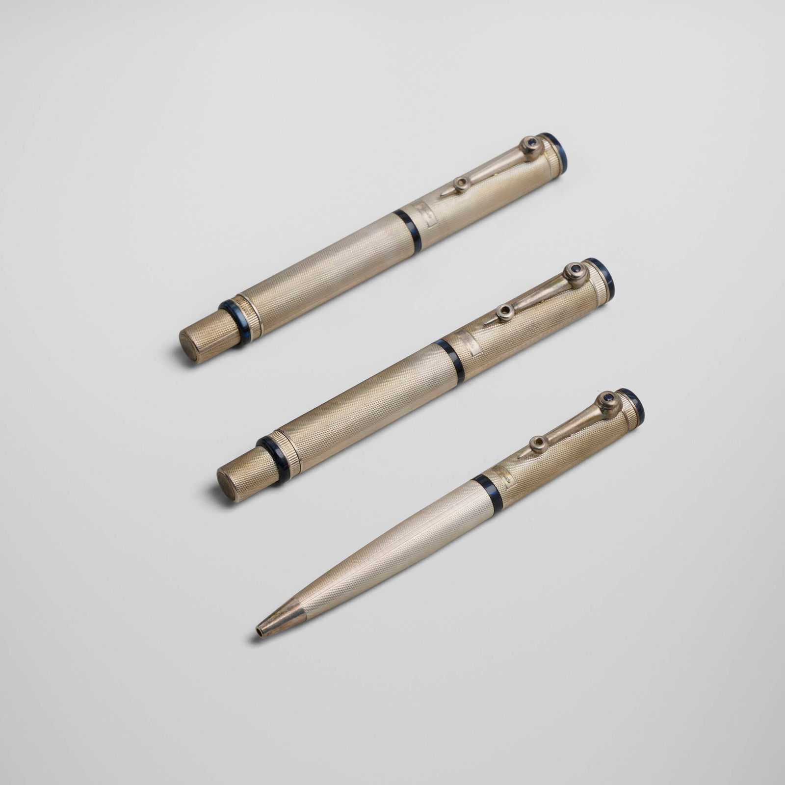Breguet, Classique three-piece pen set: Breguet Classique three-piece pen set MontegrappaSwitzerland, c. 2000sterling silver, sapphire, 18k white gold nib, lacquered wood pen (each): 5.375 h x 0.75 w x 0.5 d in (14 x 2 x 1 cm)