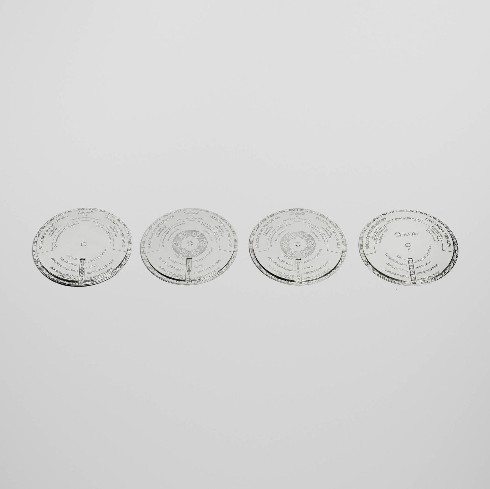 Christofle, Oenologie disques / wine coasters, set of four: Christofle Oenologie disques / wine coasters, set of four France, c. 1998-2008silver-plated metal 0.25 h x 5 dia in (1 x 13 cm) Coasters feature a dial that indicates when to open a vintage Fr