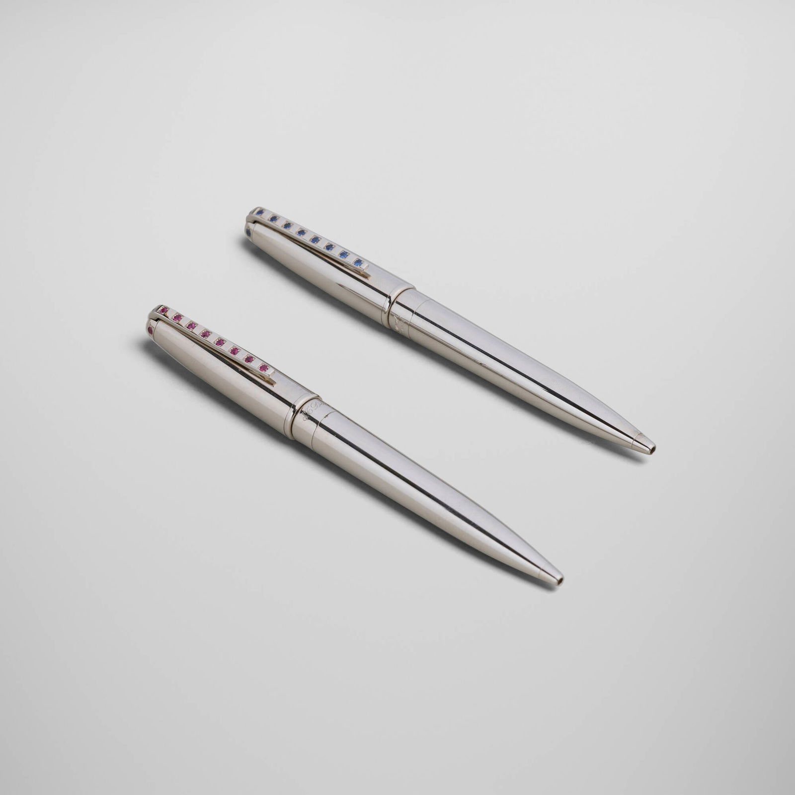 S.T. Dupont, Sky and Fire ballpoint pens, set of two: S.T. Dupont Sky and Fire ballpoint pens, set of two France, 2001 silver-plated metal, ruby, sapphire, acrylic, palladium-plated metal pen: 5.375 h x 0.625 w x 0.5 d in (14 x 2 x 1 cm) night & light
