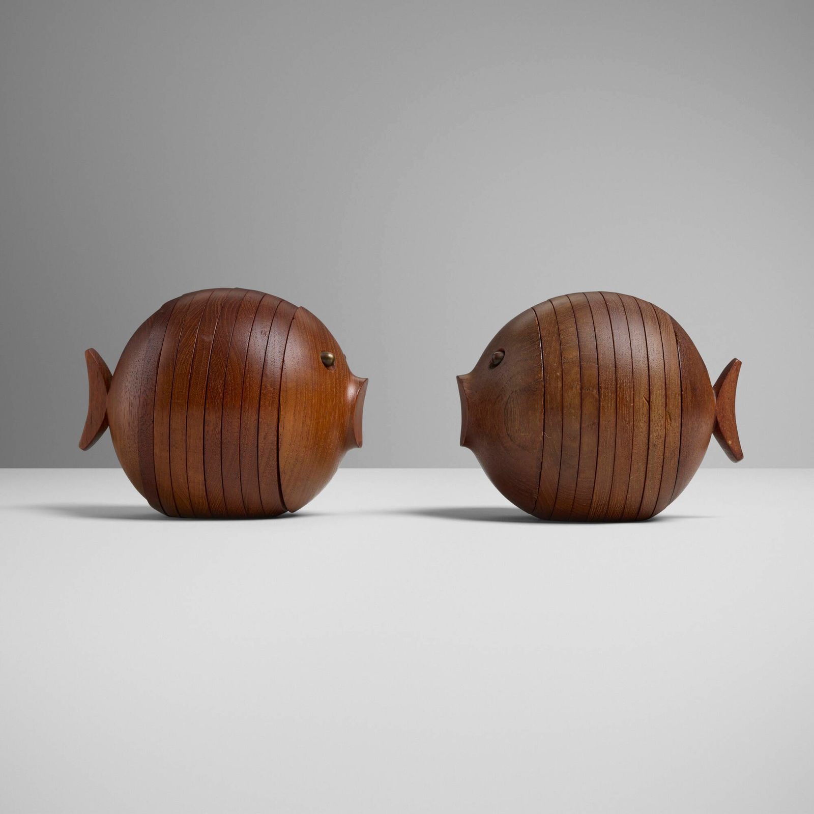 Ernst Henriksen, Puffer Fish nesting coaster sets, pair: Ernst Henriksen Puffer Fish nesting coaster sets, pair Denmark, c. 1980 teak, brass 5.25 h x 7 w x 5.5 d in (13 x 18 x 14 cm) Each set is comprised of eight coasters; sixteen coasters total.