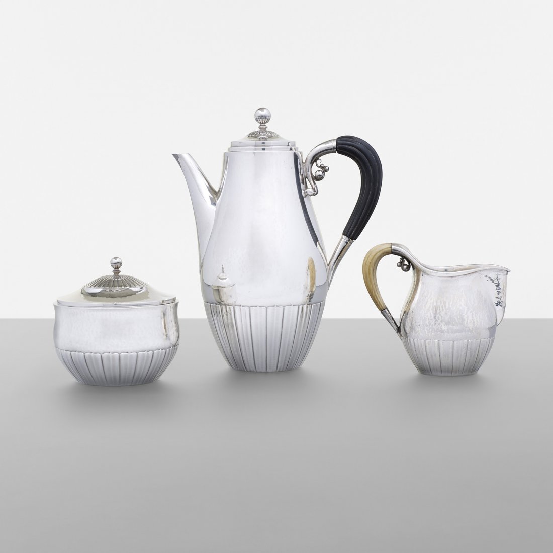 Johan Rohde coffee service: Johan Rohde coffee service Georg Jensen Denmark, 1925 sterling silver, ebony, ivory 5.75 w x 3.5 d x 7 h inches Service includes coffee pot, creamer and lidded sugar vessel. Signed with impressed manu