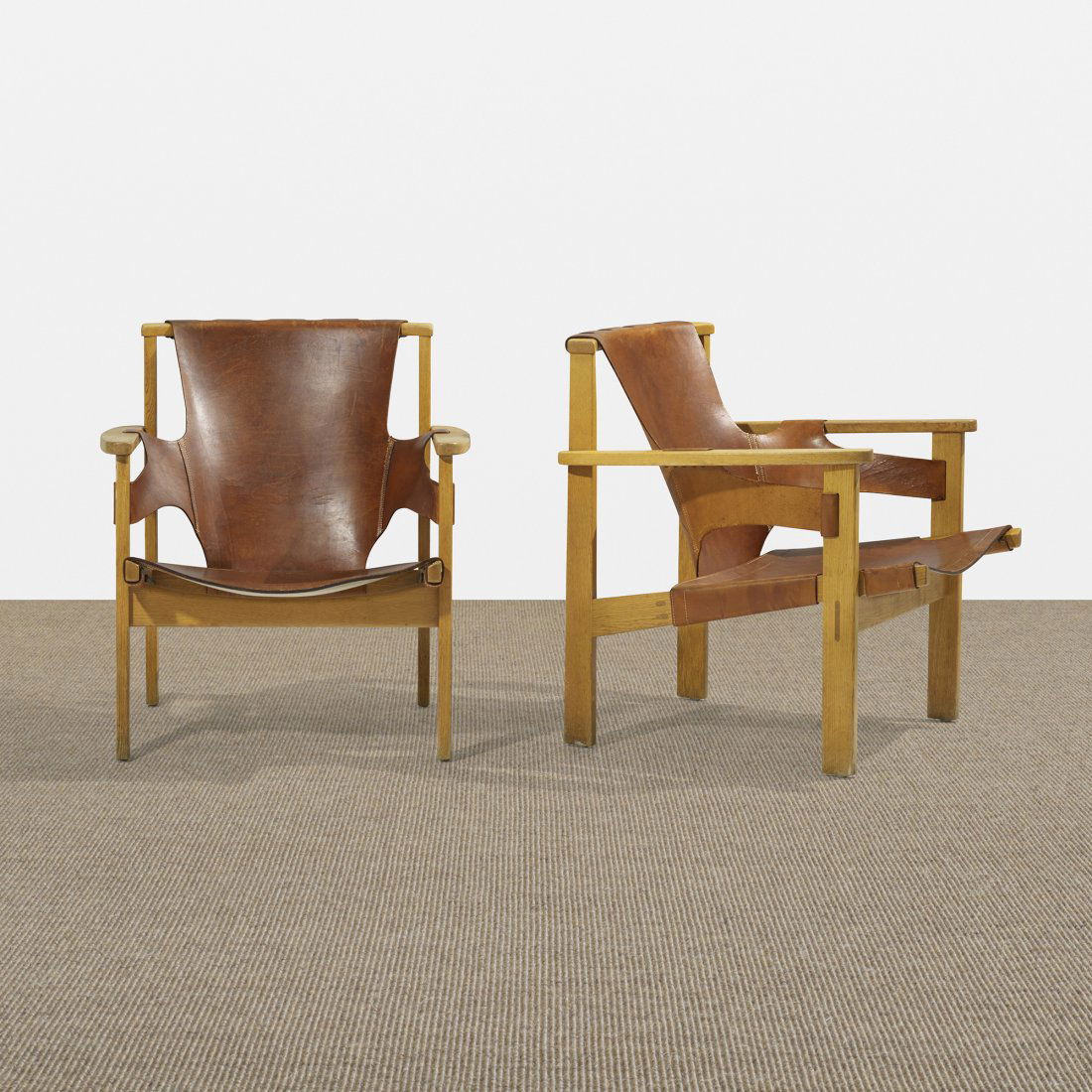 Carl-Axel Acking Trienna armchairs, pair: Carl-Axel Acking Trienna armchairs, pair Nordiska Kompaniets Verkstader Sweden, 1957 oak, leather, brass 27.5 w x 29 d x 30.25 h inches Literature: Svenska Stolar: Och Deras Formgivare 1899-2001, Gord