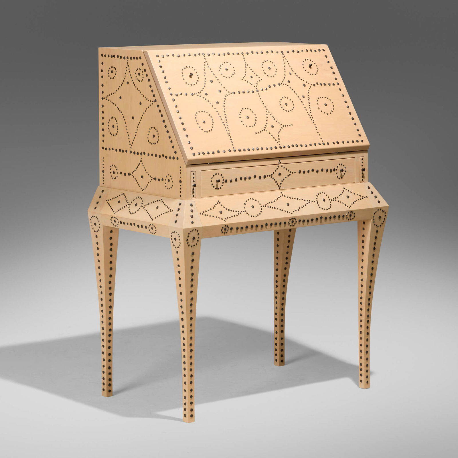 Judy Kensley McKie, Writing desk: Judy Kensley McKie Writing desk USA, 2004 basswood, blackened iron tacks, vinyl 44.5 h x 34 w x 20 d in (113 x 86 x 51 cm) Desk features a drop-front writing surface concealing two drawers and