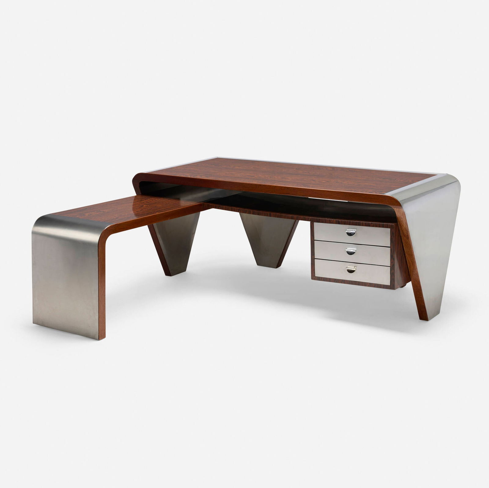 In the style of Joseph-Andre Motte, Desk and return: In the style of Joseph-Andre Motte Desk and return France, c. 1970laminate, stainless steel, mahogany 29.5 h x 74 w x 66.5 d in (75 x 188 x 169 cm) Desk features a hanging secretary with three
