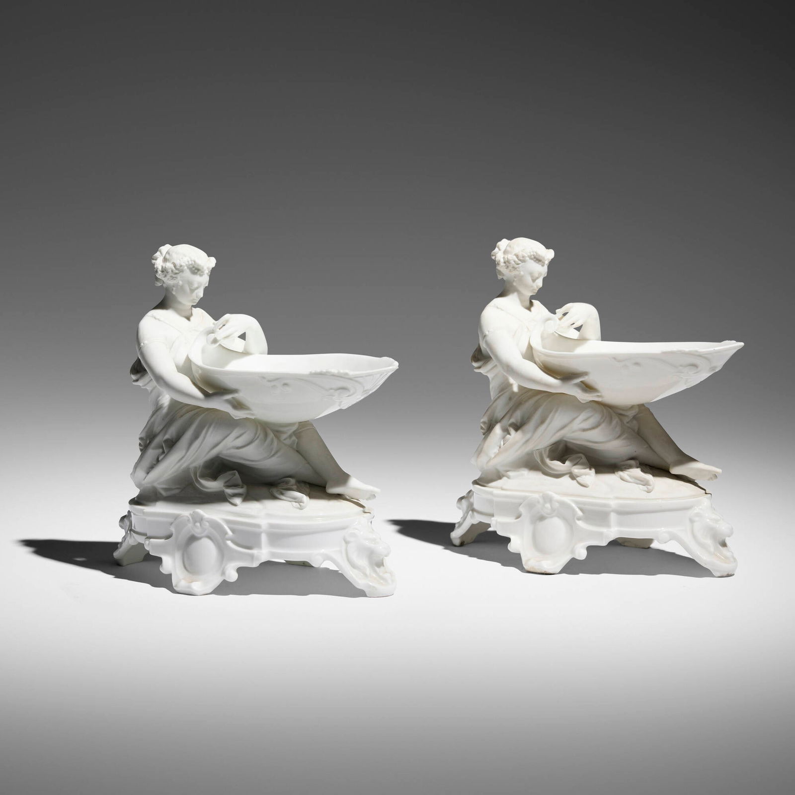 German, Neoclassical-style vide-poches, pair: German Neoclassical-style vide-poches, pair early 20th century glazed and bisque porcelain 8.5 h x 5.25 w x 8.5 d in (22 x 13 x 22 cm) Provenance: JF Chen, Los Angeles This work will ship from