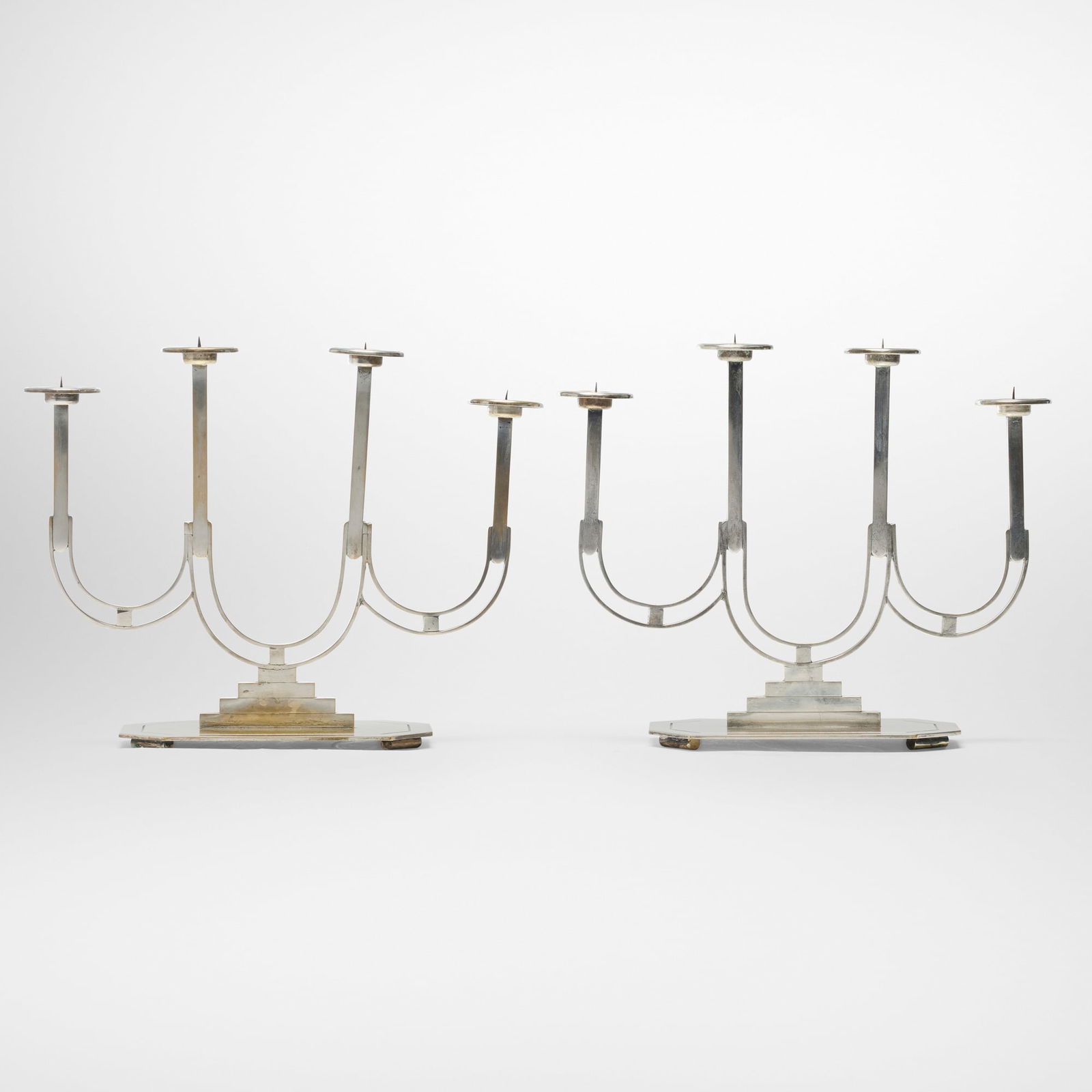 German, Art Deco candelabra, pair: German Art Deco candelabra, pair c. 1940 silver plate 10.75 h x 11.5 w x 4.4 d in (27 x 29 x 11 cm) Impressed manufacturer's mark to underside 'E.M. Handarbeit'. Provenance: JF Chen, Los Angeles 