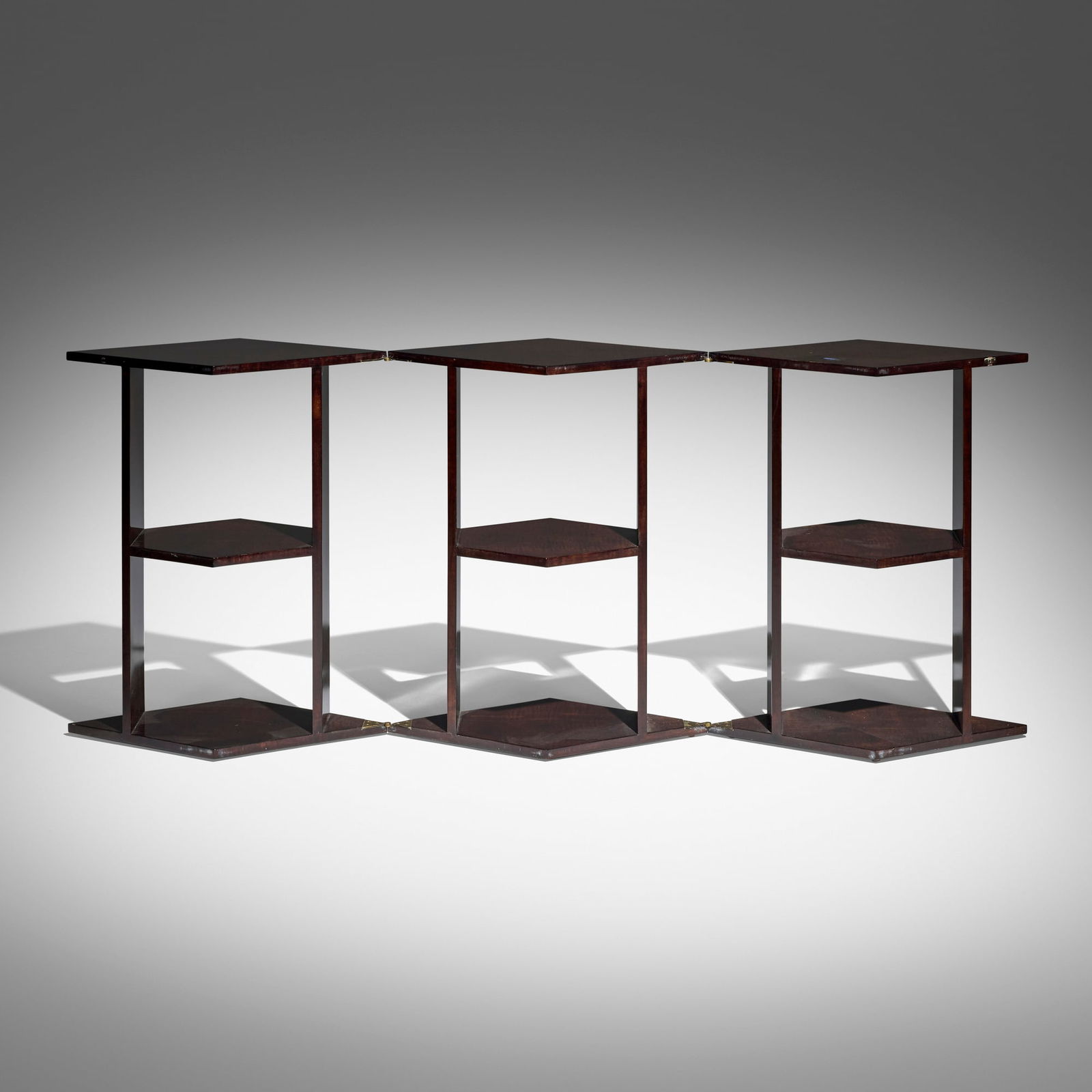 After Eugene Printz, Convertible table: After Eugene Printz Convertible table 20th century palm wood, brass 28.25 h x 24 w x 27.5 d in (72 x 61 x 70 cm) Table converts into a three-shelf bookcase measuring 28.25 x 71 x 13.75 inches when