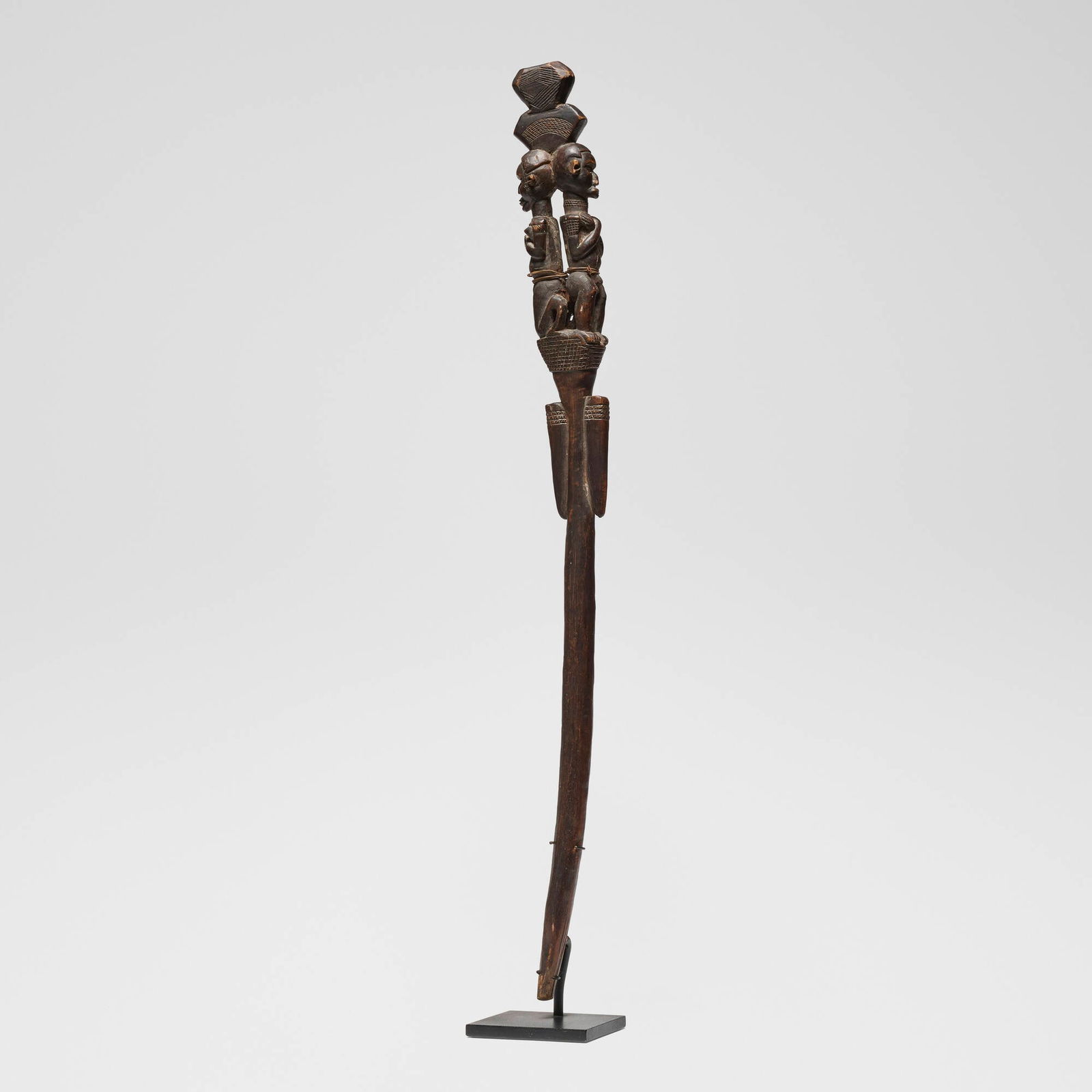 Eastern Tanzania, Janus staff with two figures: Eastern Tanzania Janus staff with two figures 20th century carved wood, plant fiber 30 h x 2.75 w x 1.5 d in (76 x 7 x 4 cm) Provenance: Jean-Pierre Hallet, Malibu | Private Collection, Los