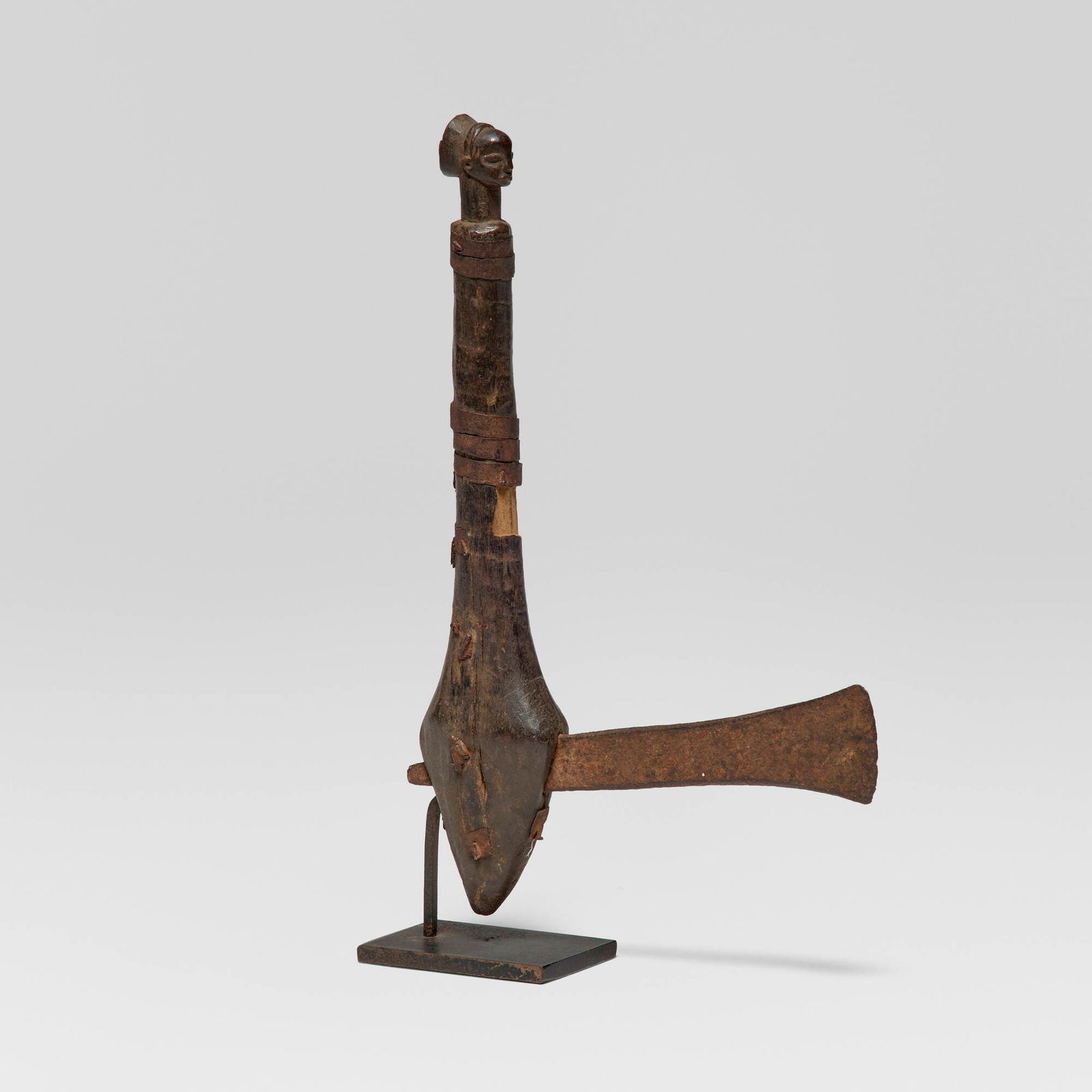 Luba, Ceremonial adze: Luba Ceremonial adze Democratic Republic of Congo, late 19th-early 20th century carved wood, iron, leather 12 h x 1.25 w x 7.5 d in (30 x 3 x 19 cm) Provenance: Jean-Pierre Hallet, Malibu |