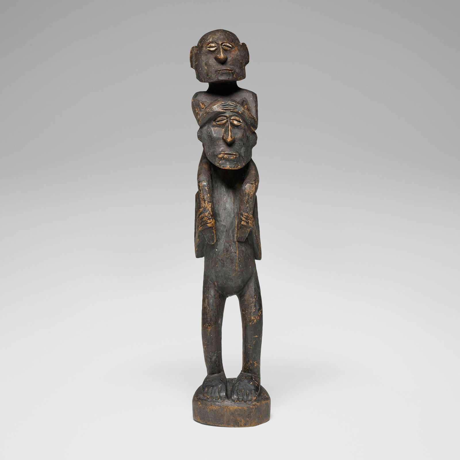 Iatmul, Stacked ancestral figures: Iatmul Stacked ancestral figures New Guinea carved wood, cowrie shells 18.5 h x 3.5 dia in (47 x 9 cm) Provenance: Collection of Marlene Shatkin, Winnetka, IL This work will ship from Chicago,